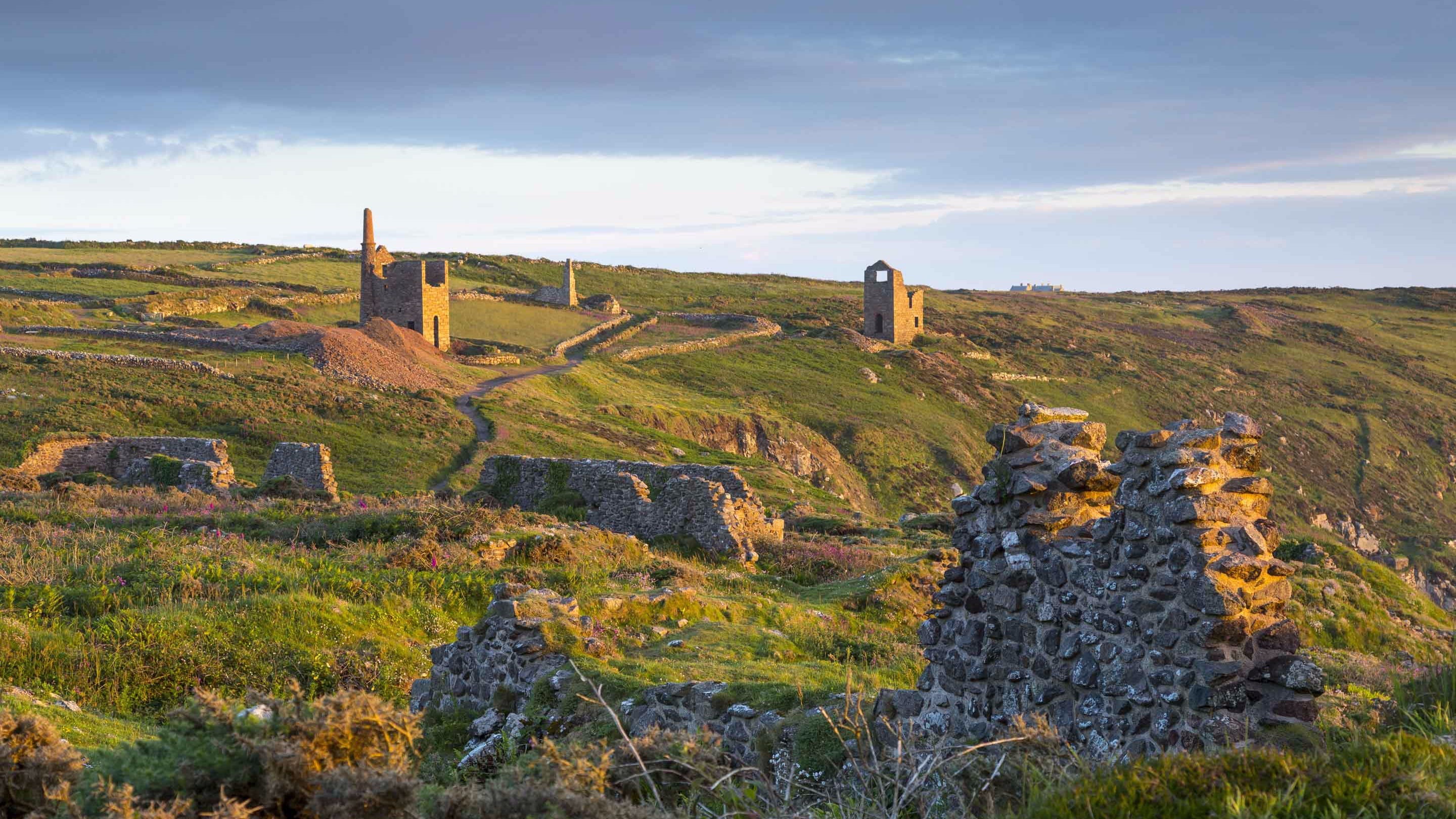 A view of the ruined engine houses, Wheal Edward and Wheal Owles, along the coastline at Botallack, Cornwall