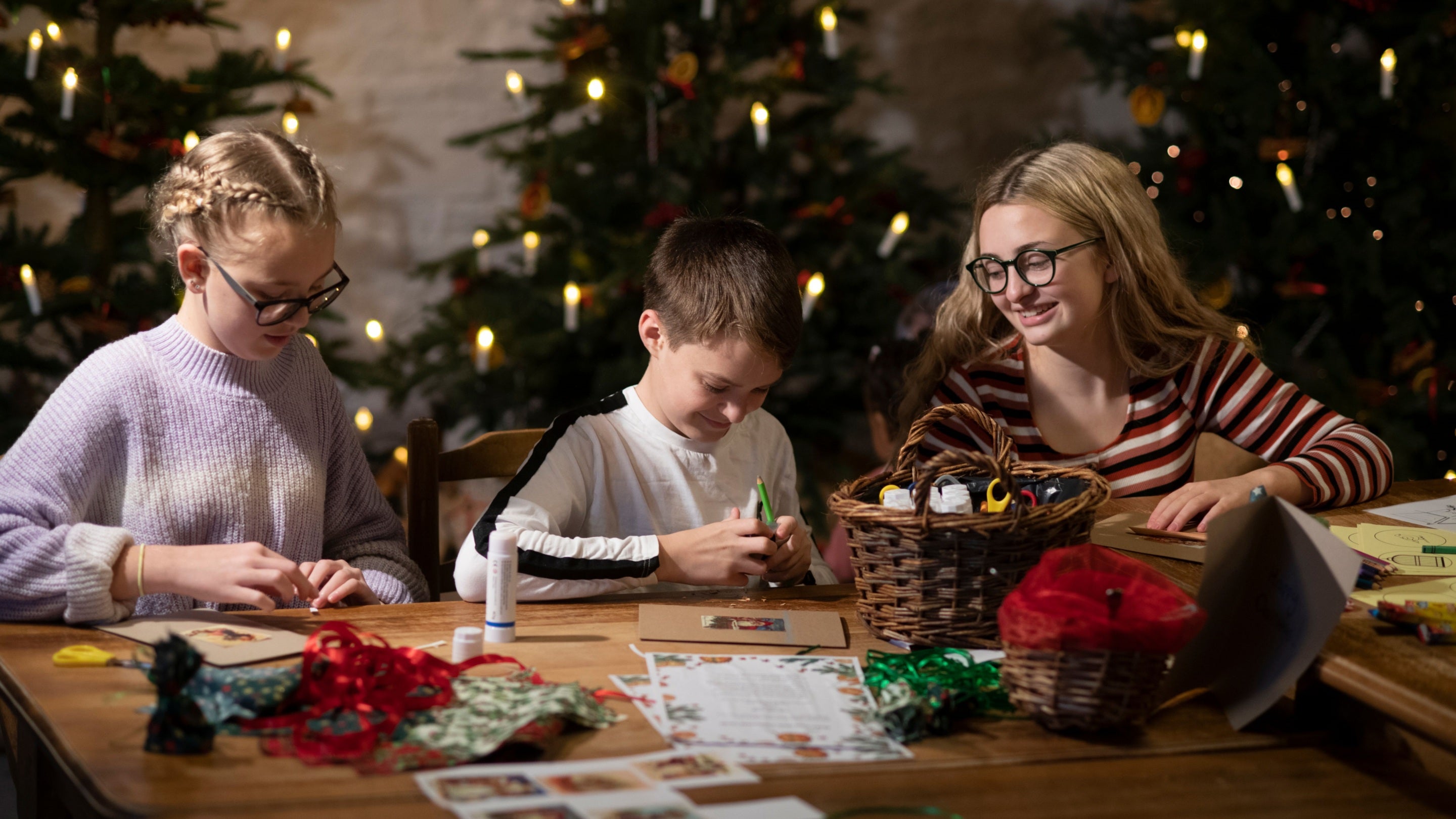 Family taking part in Christmas crafts at Cotehele Mill, Cornwall