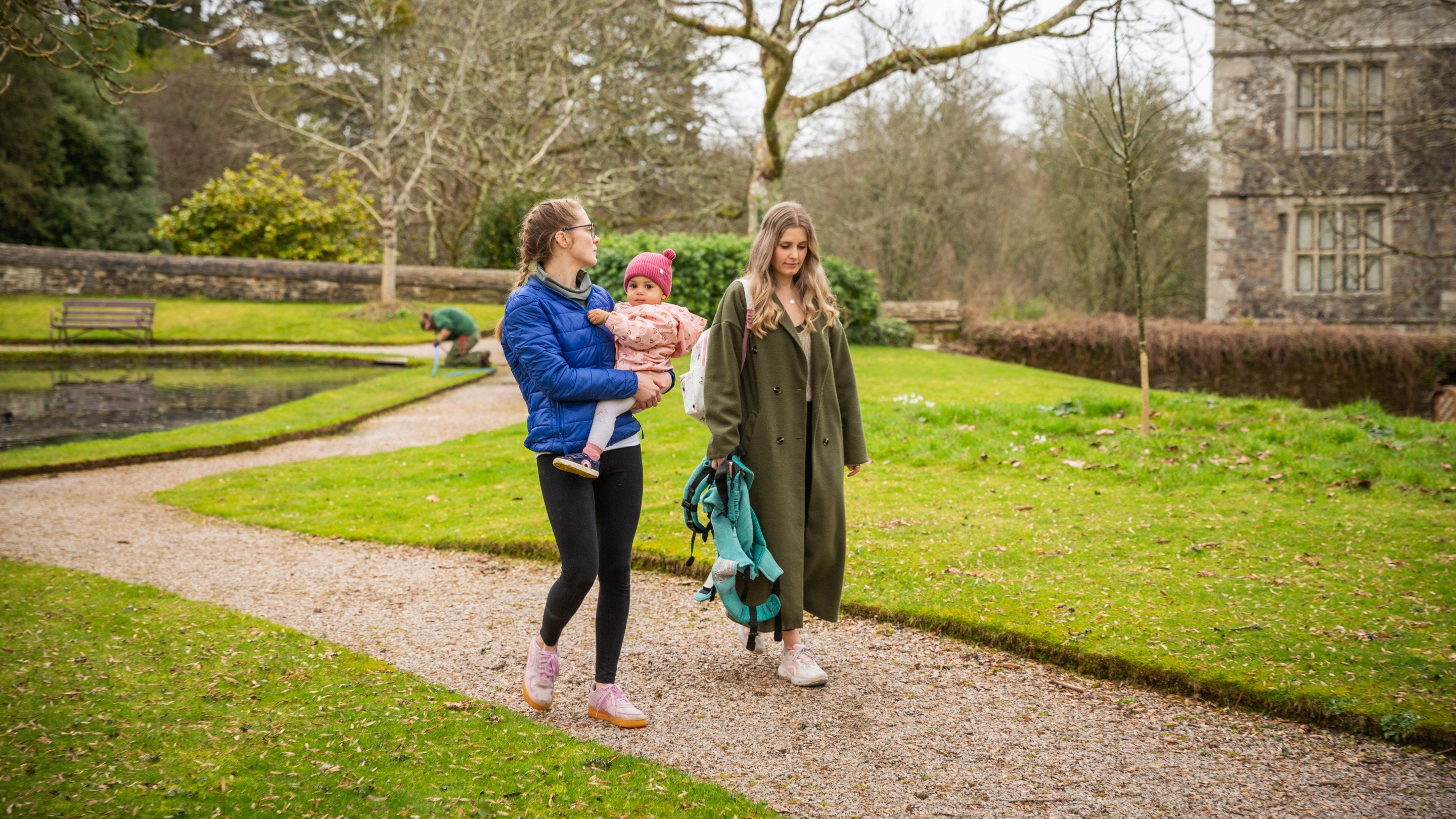 Family walking along a gravel path in the Upper Garden at Cotehele, Cornwall