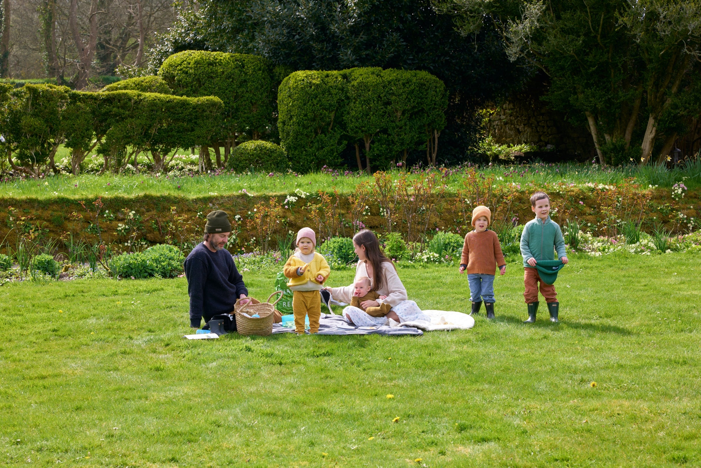 family enjoying a picnic in the garden at Godolphin
