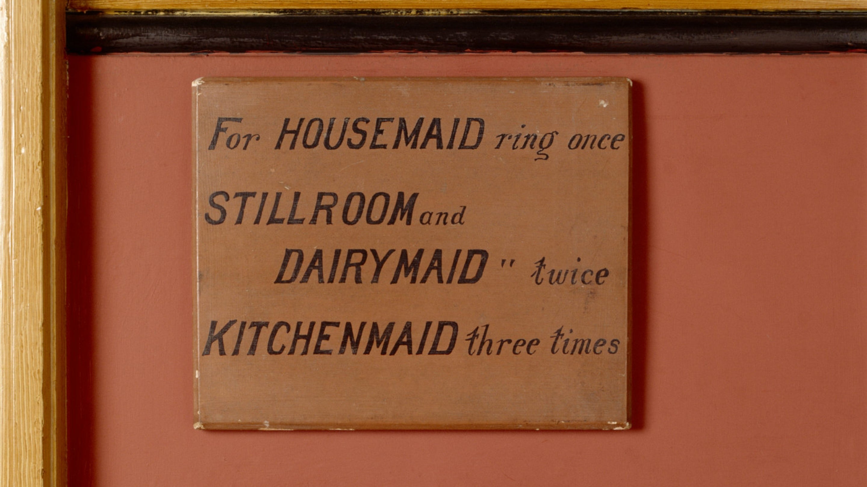 Detail of a panel with bell push buttons, labelled for the housemaid, stillroom, dairymaid and kitchenmaid