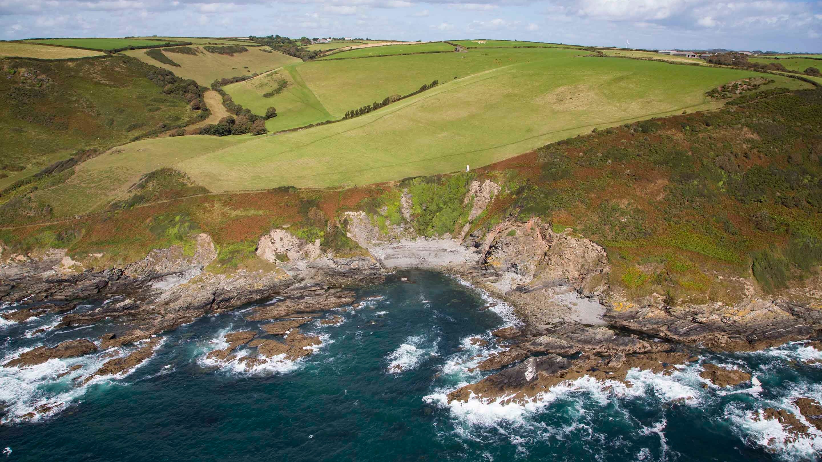 View of the jagged cove at Lansallos from a high angle above the sea