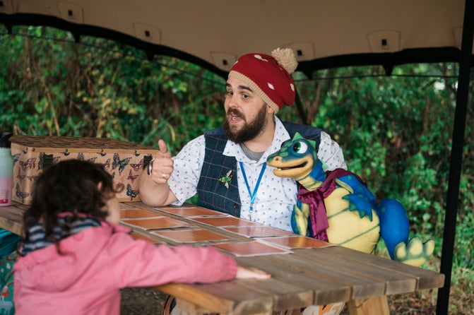 James and his dragon puppet Jasper telling stories