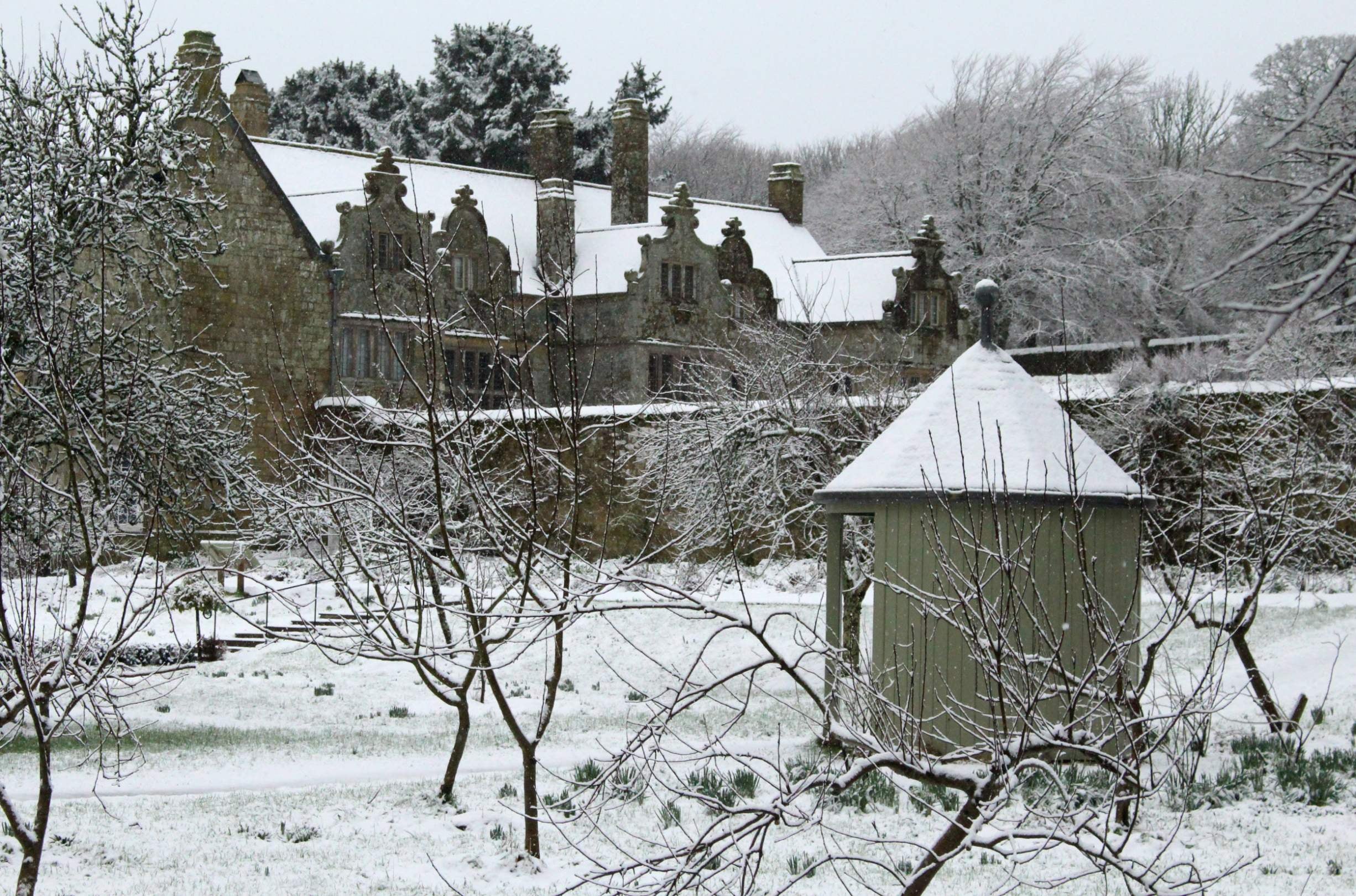 An image of Trerice covered in snow, taken from the orchard, Trerice, Cornwall