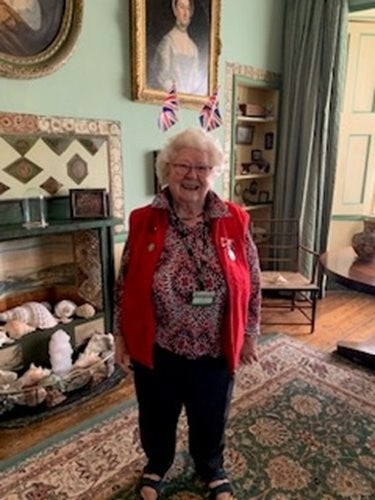 Gill Laws, volunteer stands in A la Ronde Drawing Room on Charles III coronation