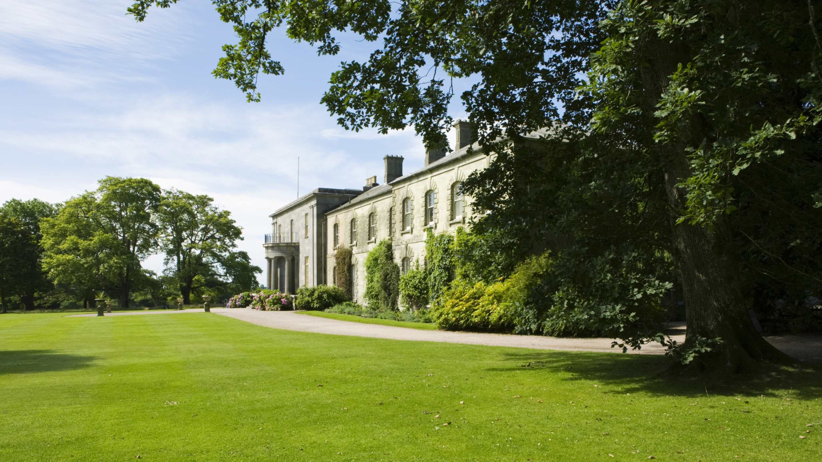 A view of the house in summer at Arlington Court, Devon