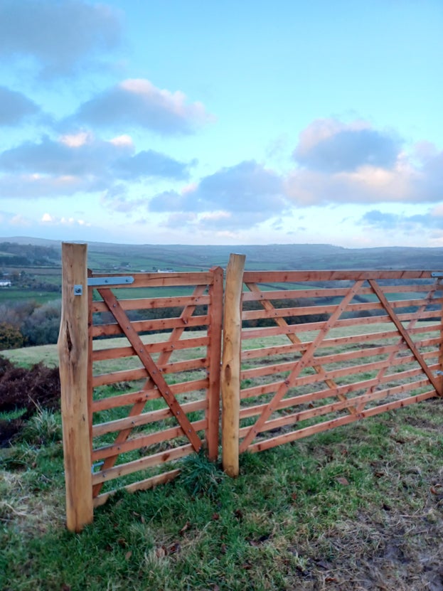 A new fence with a gate in a field