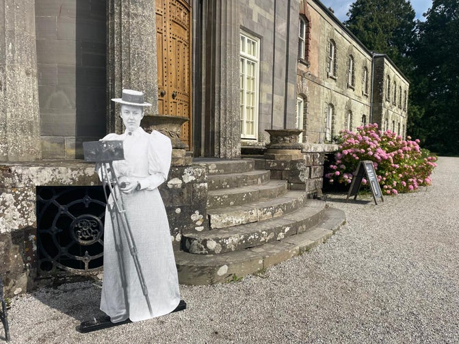 A printing life size figure of Rosalie Chichester with an old camera in front of her