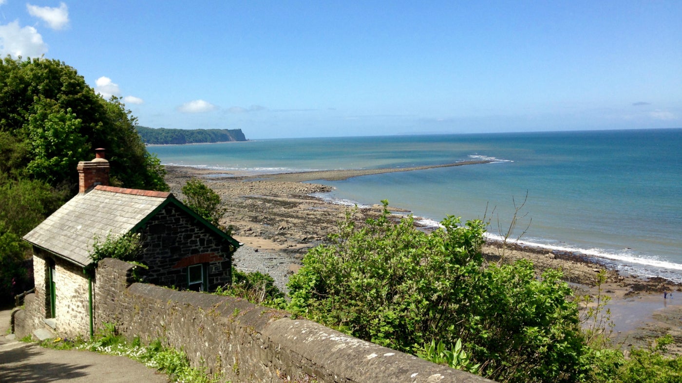 Small stone dwelling on hill overlooking beach