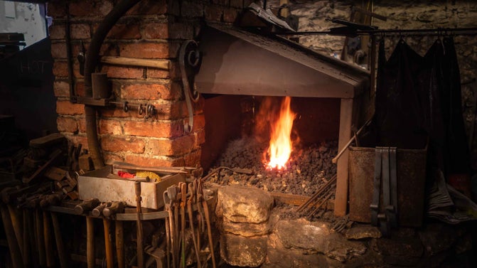Branscombe's forge fire surrounded by tools