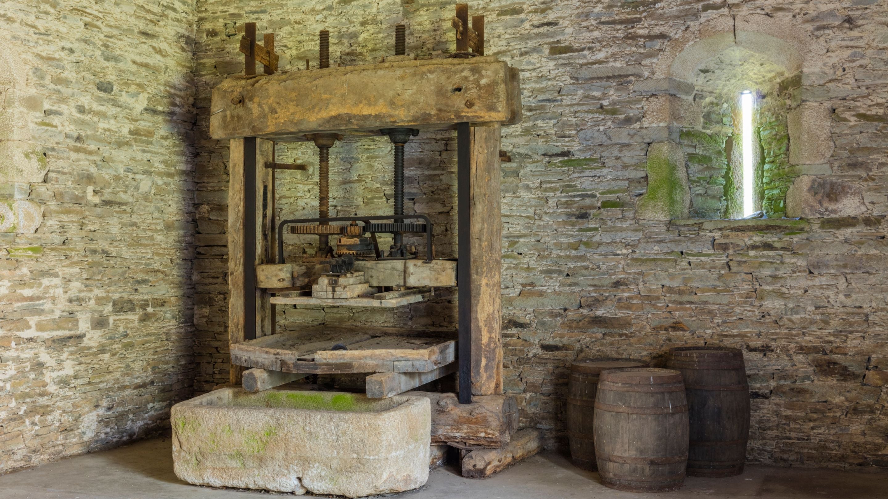 The apple press at the north end of the Great Barn at Buckland Abbey, Devon