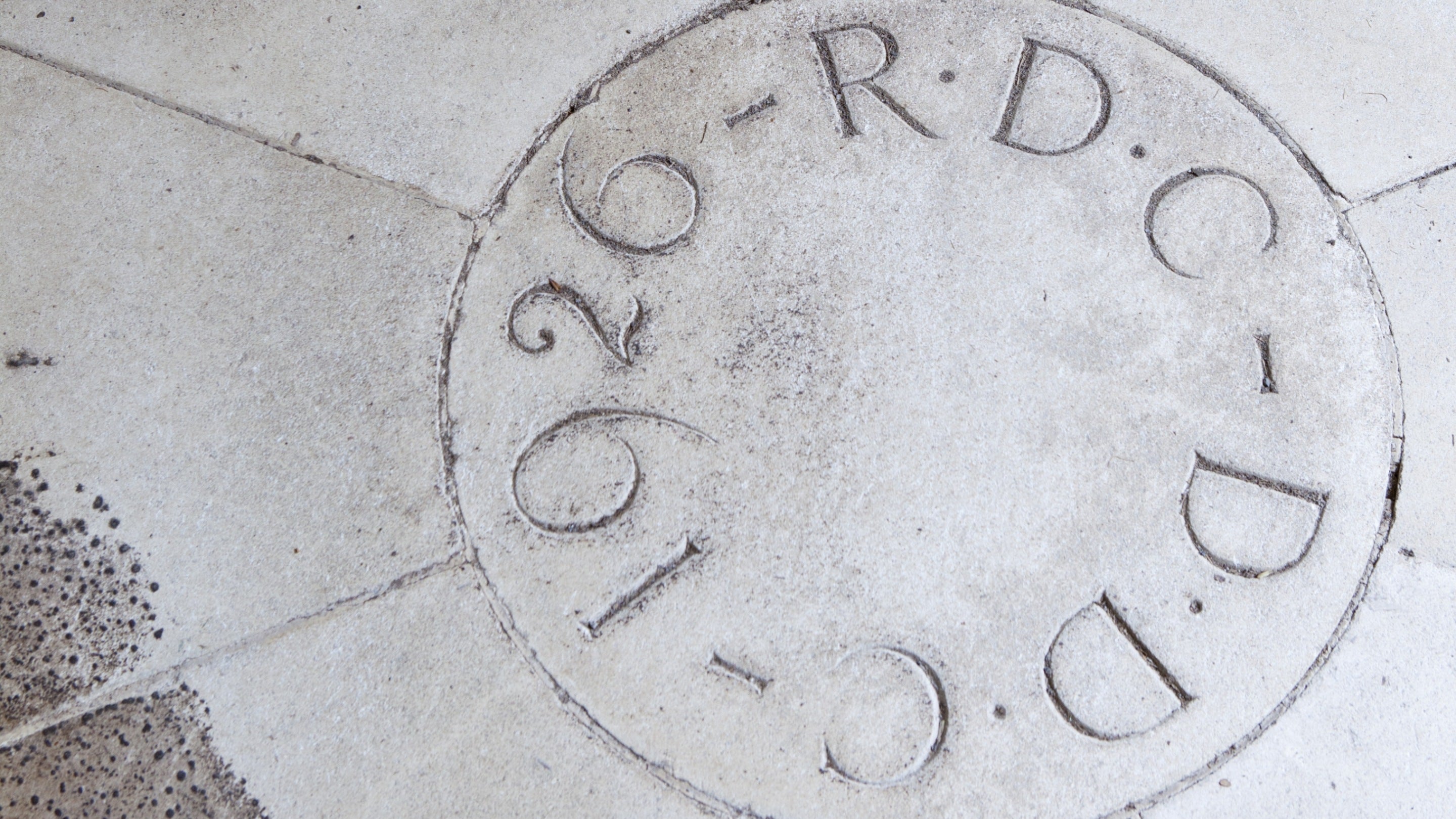The initials of Rupert and Dorothy D'Oyly Carte set into the stonework of the Entrance Hall at Coleton Fishacre, Devon