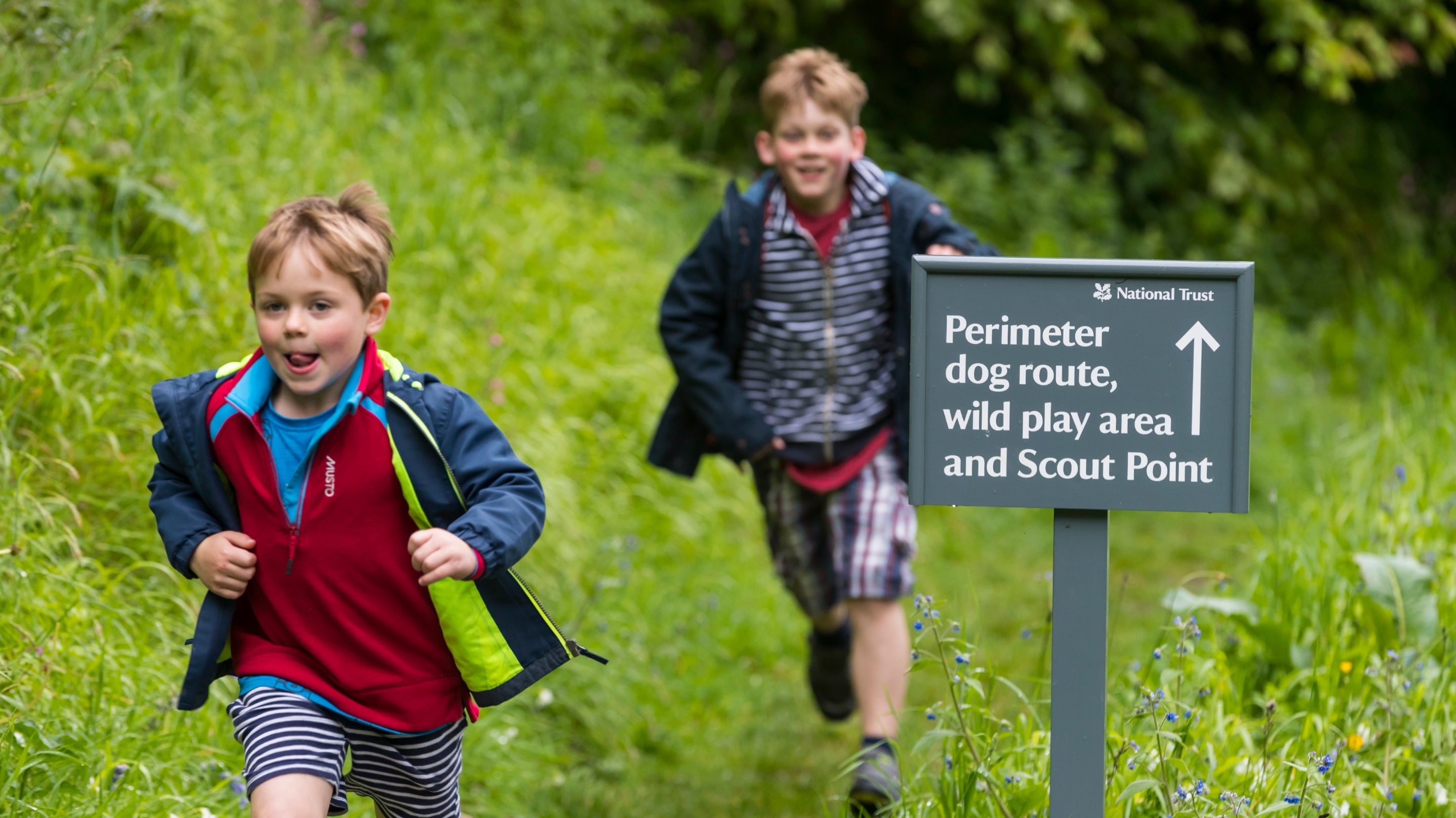 Children running in the garden at Coleton Fishacre, Devon