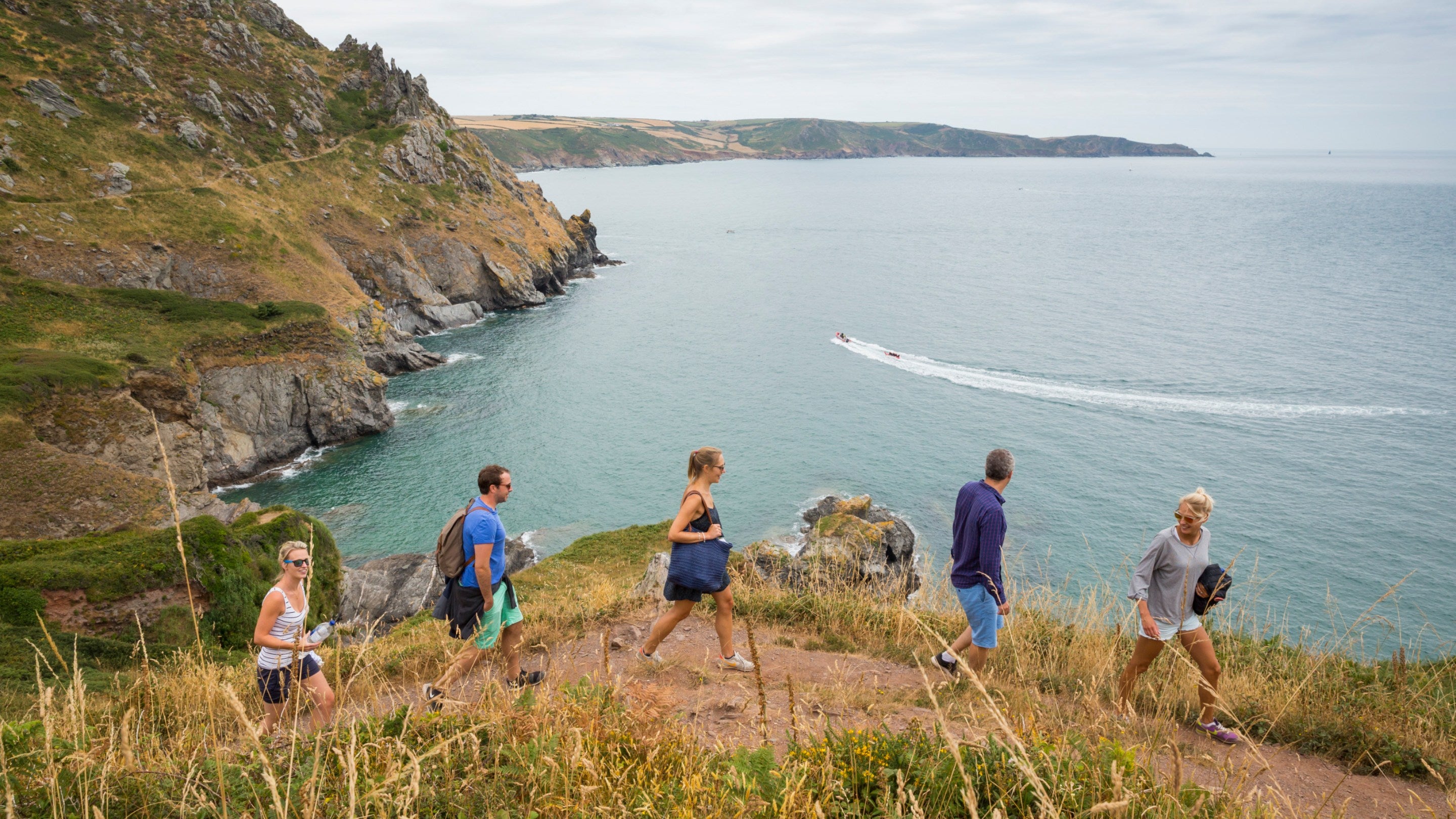 Walkers on the South West Coast Path at East Soar, Devon