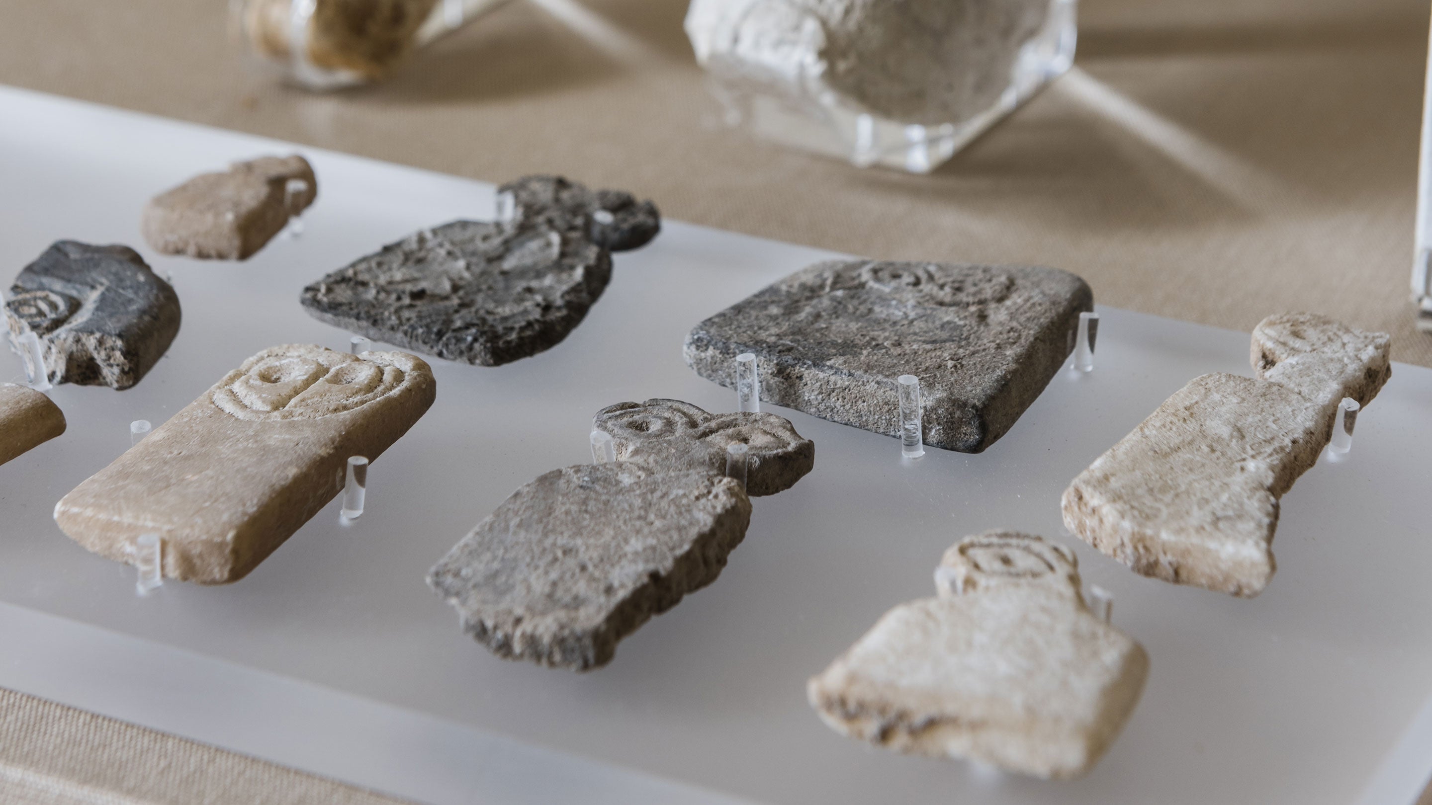 A collection of eight stone archaeological sherds. The stone is flat and engraved.