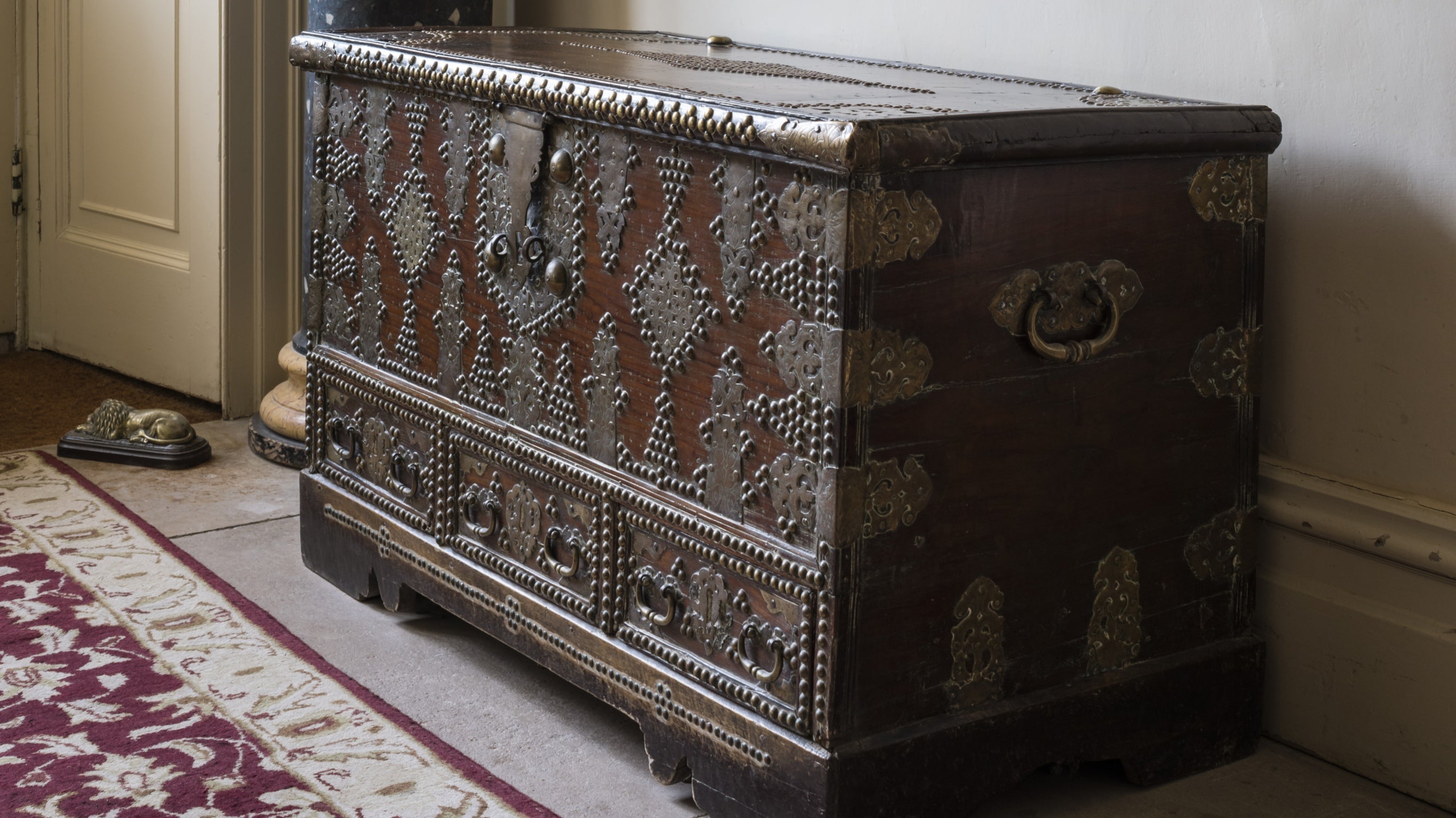 A brass-studded Baghdad chest in the entrance hall at Greenway, Devon