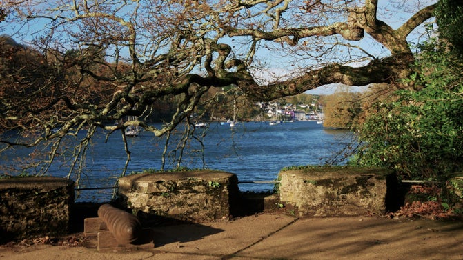 Original canon on the stone battery looking towards the River Dart on a sunny winter's day.