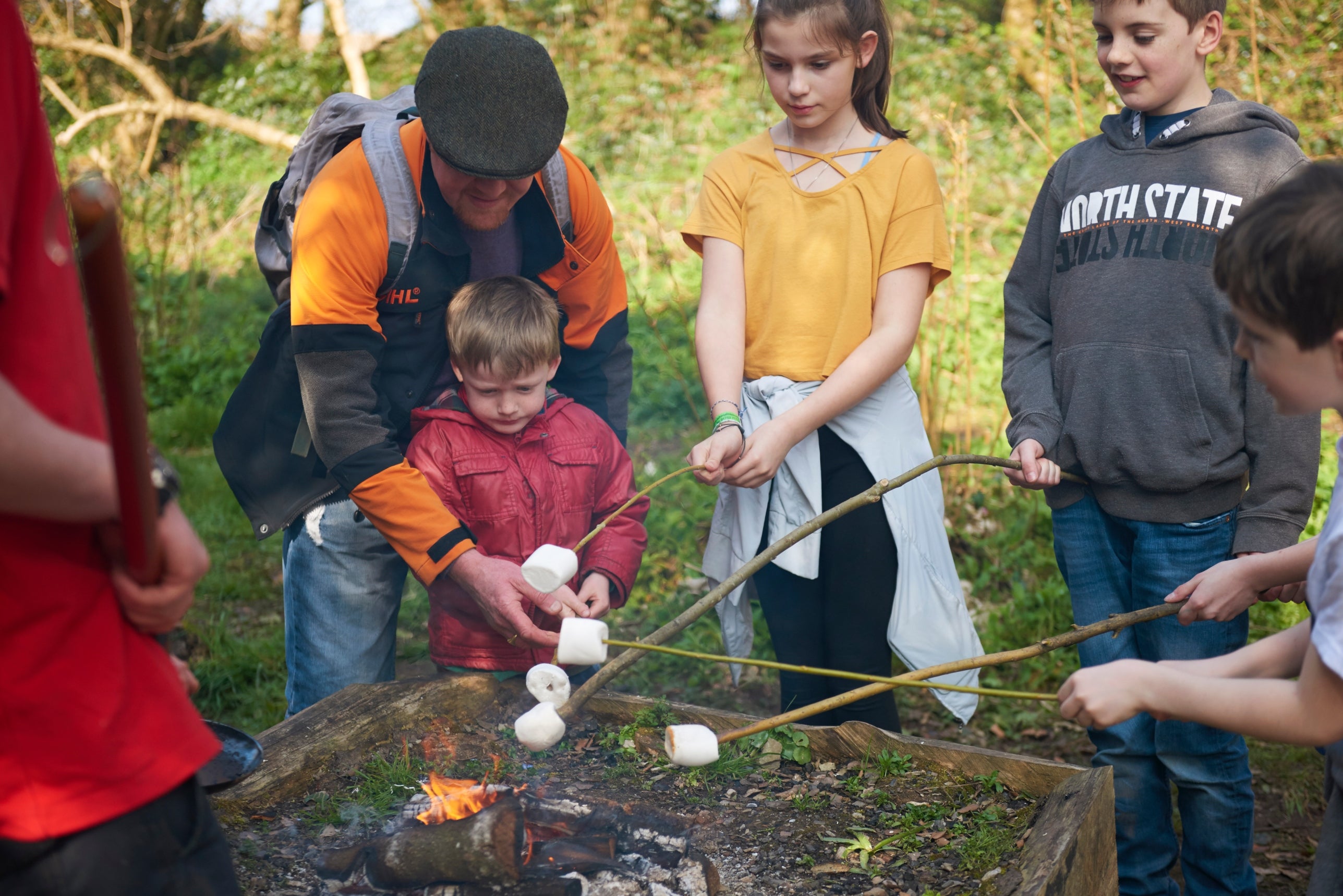 Children toasting marshmallows on a campfire