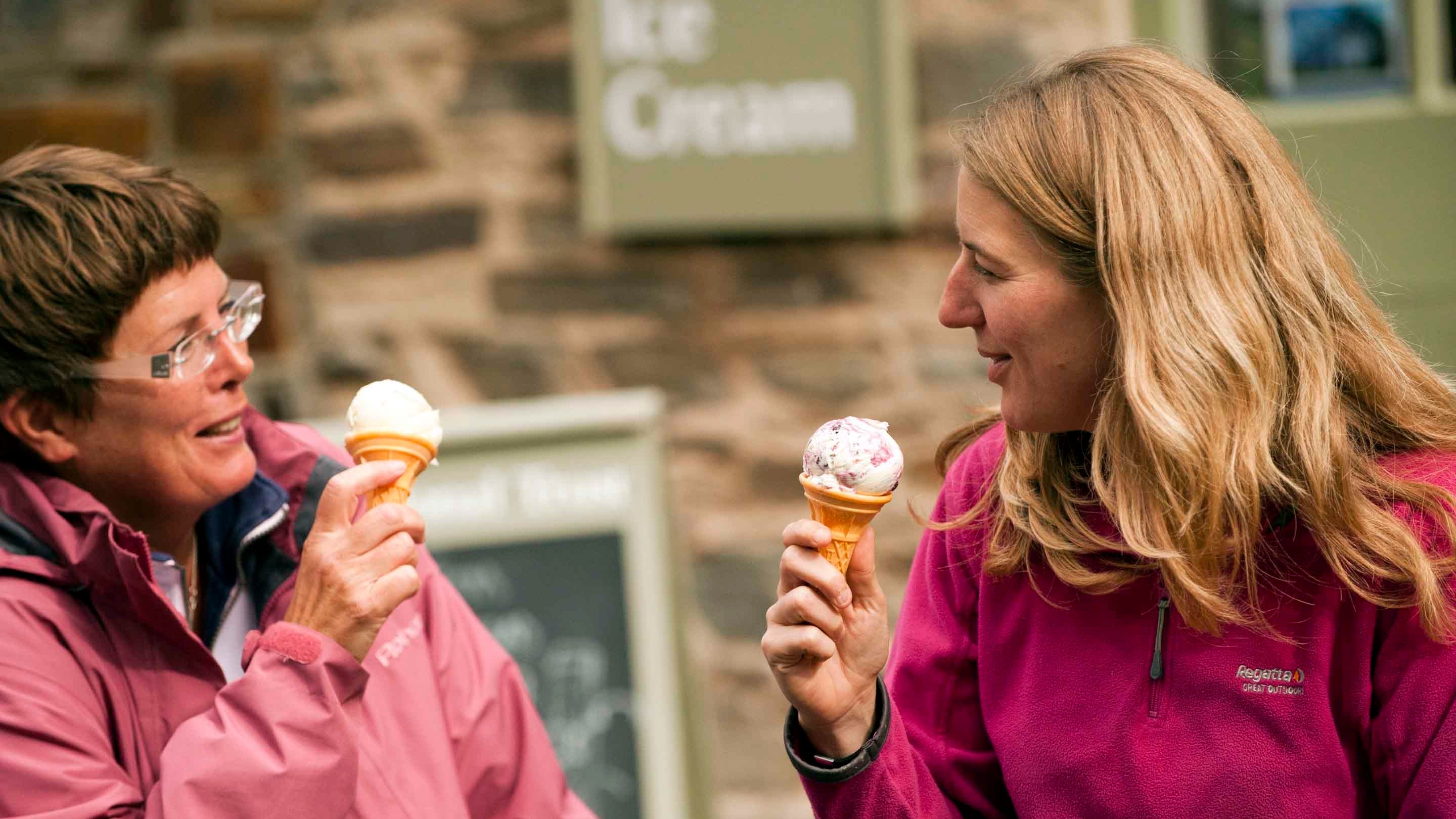 Visitors enjoying an ice-cream from the National Trust shop at Heddon Valley, Devon