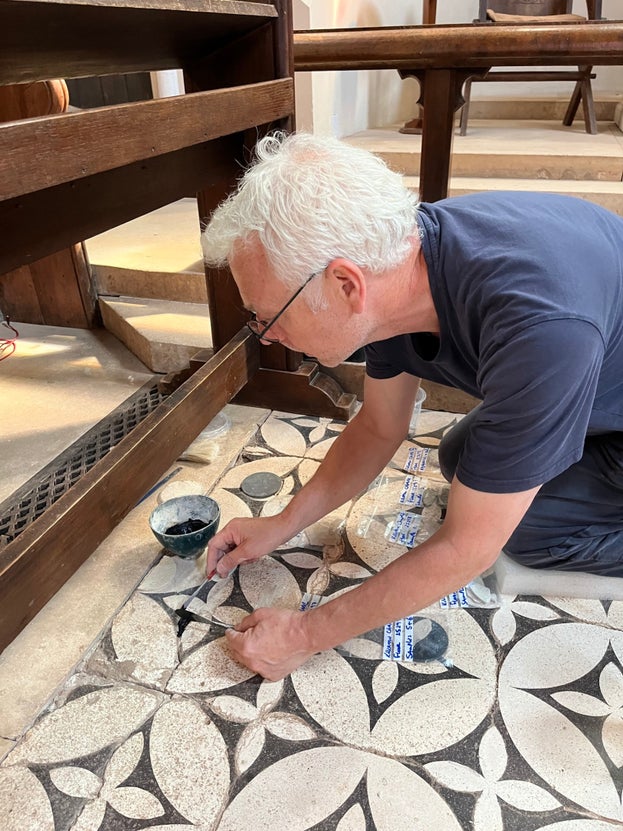 Conservation expert looking at the tiles on the Chapel floor