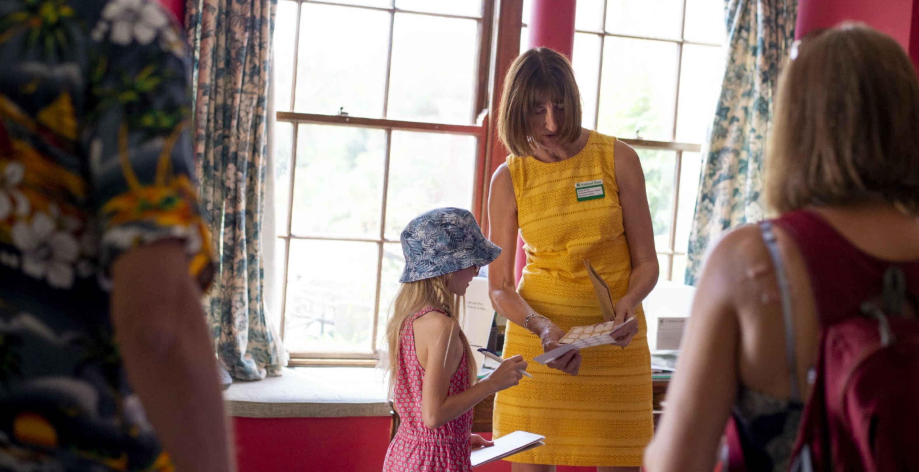Volunteer Room Guide at Killerton speaking with viistors