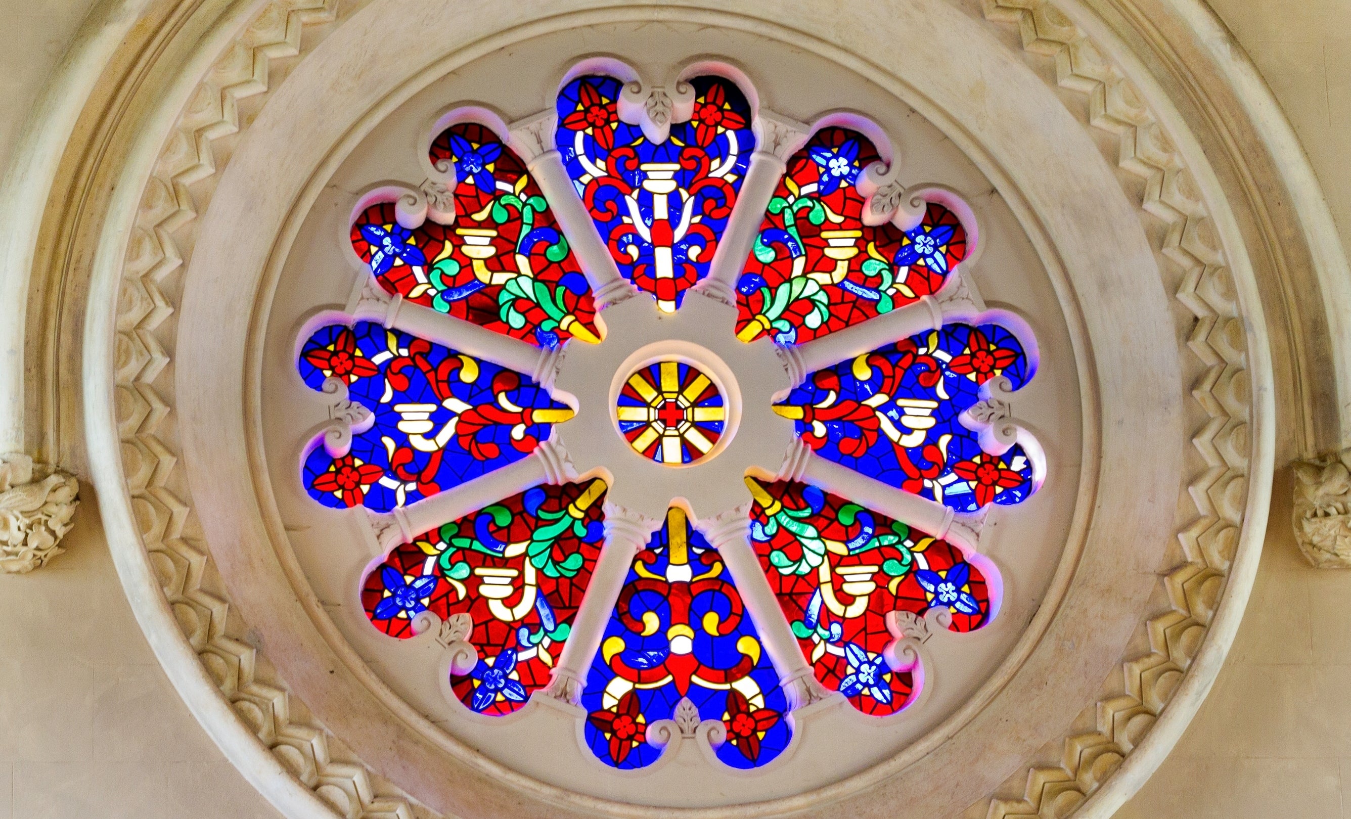The coloured stained glass rose window of the Acland chapel