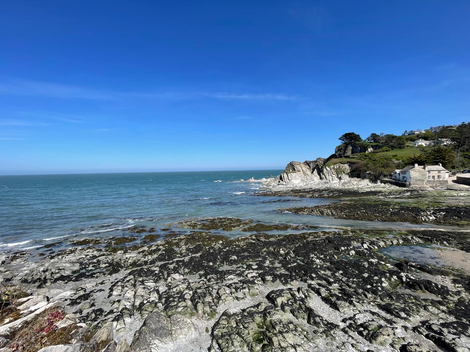 Over looking a bay with a low tide and exposed rockpools on the beach
