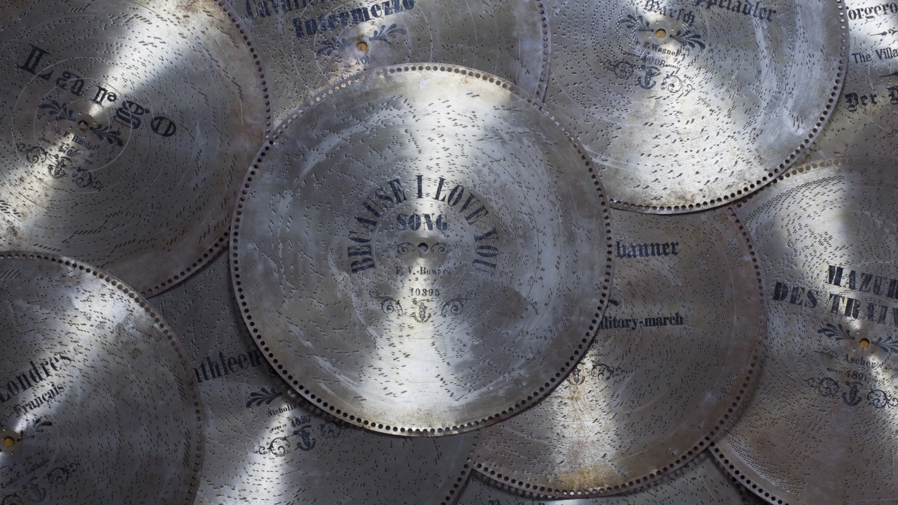 A collection of metal discs that rotate producing music inside a polyphon at Overbeck's, Sharpitor, Devon