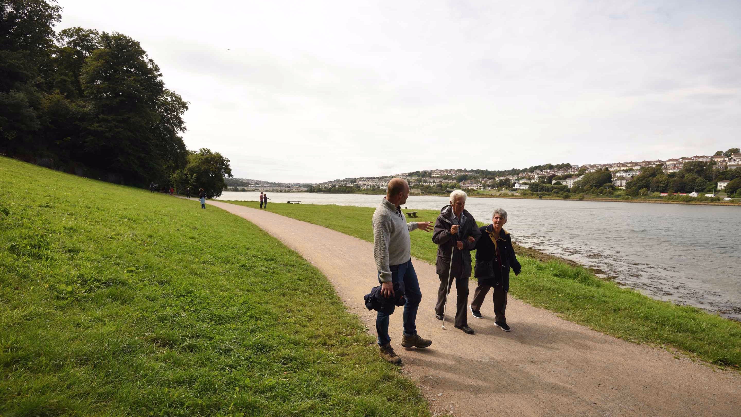 Visitors walk along a path beside the River Plym at Saltram, Devon