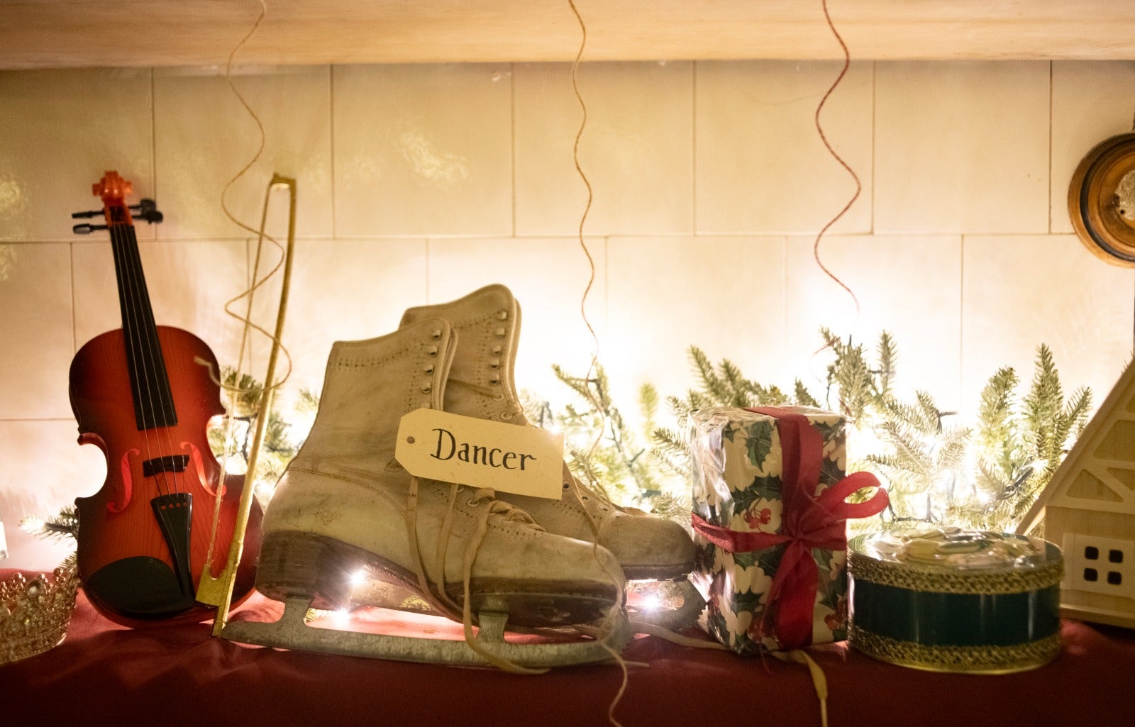 Image shows ice skating shoes, a violin and wrapped presents as part of Father Christmases toy making area at Saltram