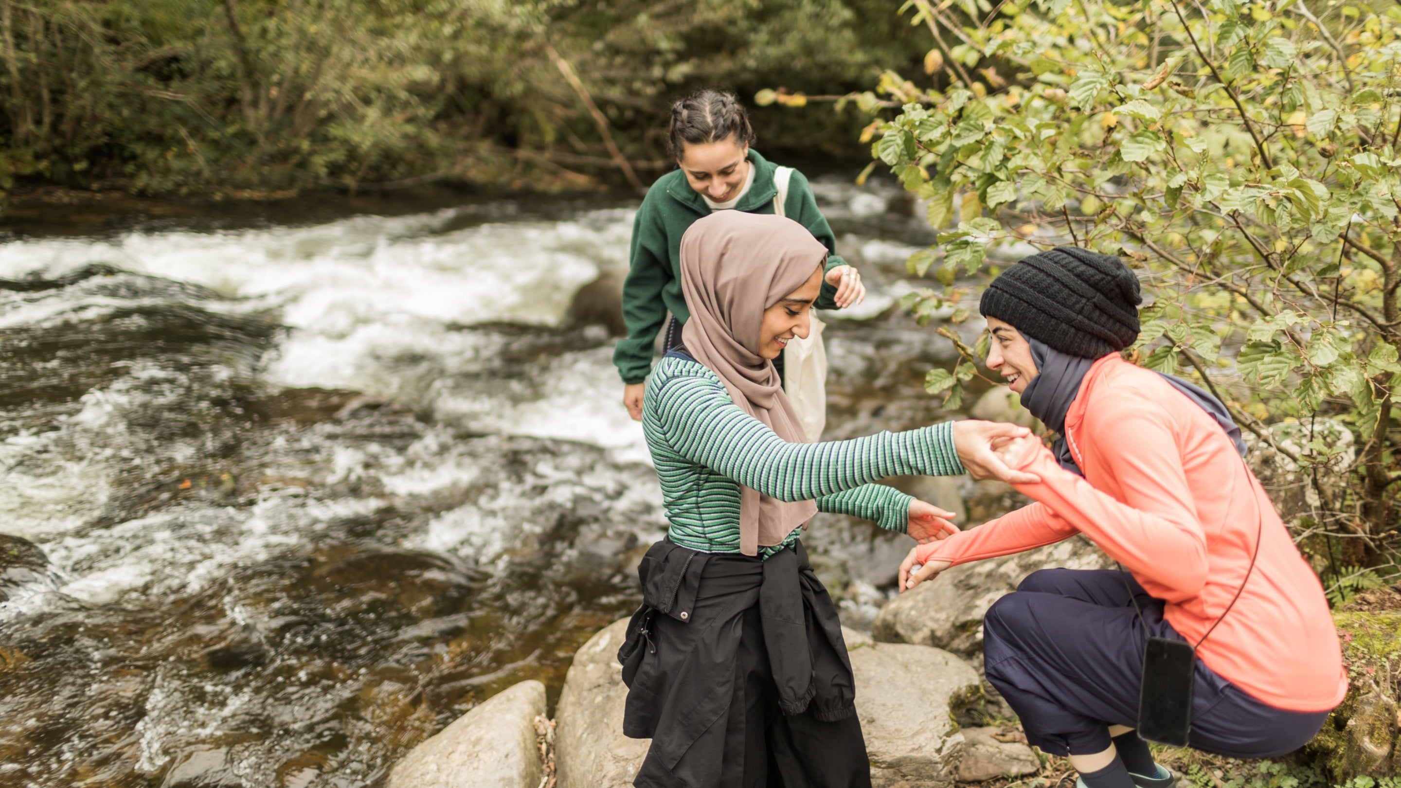 The Muslim Hikers cross the waterfall on the Lynmouth circular walk via Watersmeet and Countisbury, Devon