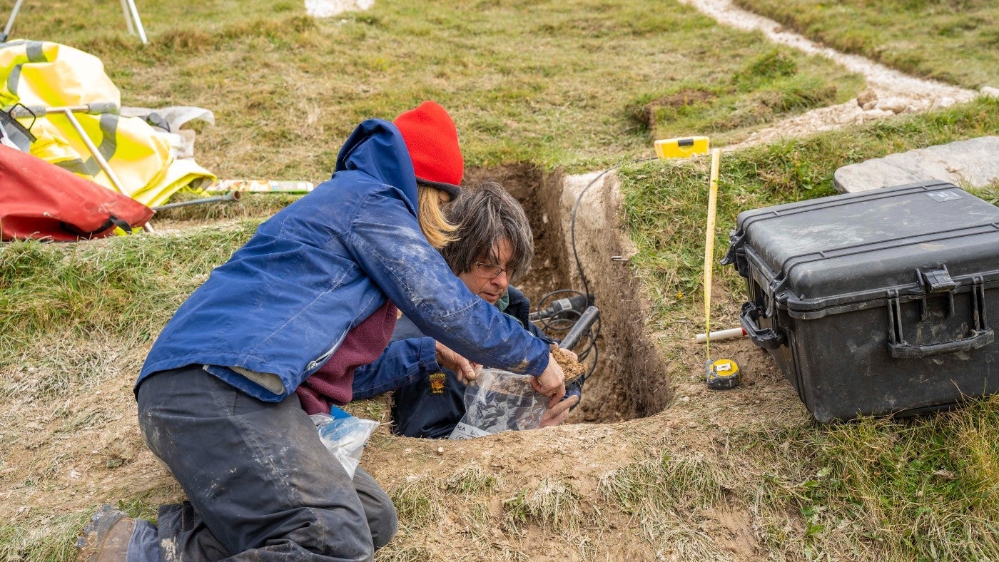 Archaeologists bag up soil samples taken from the Cerne Giant