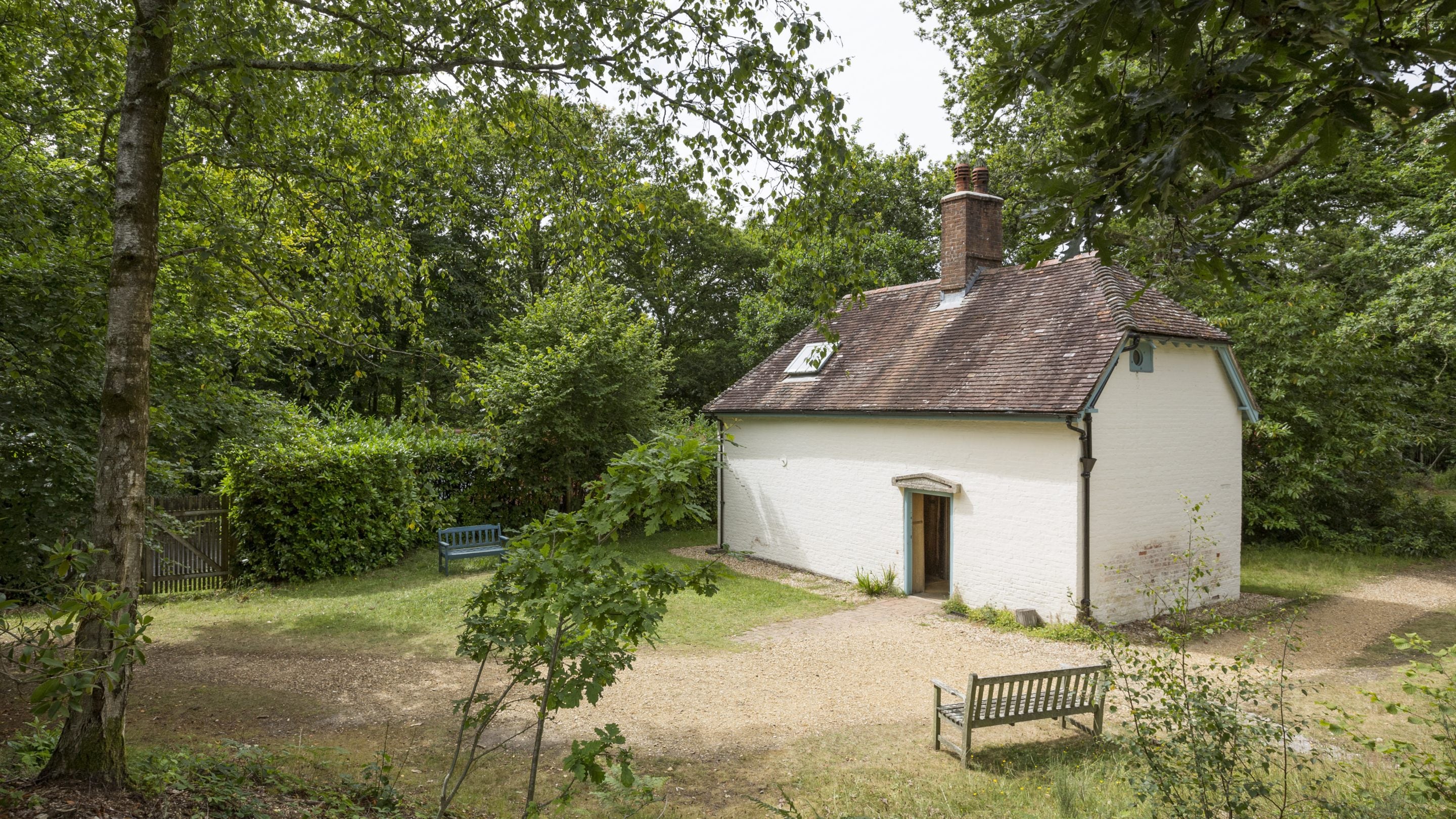 View of Clouds Hill, the small woodsman's cottage, in Dorset with trees and bushes surrounding it