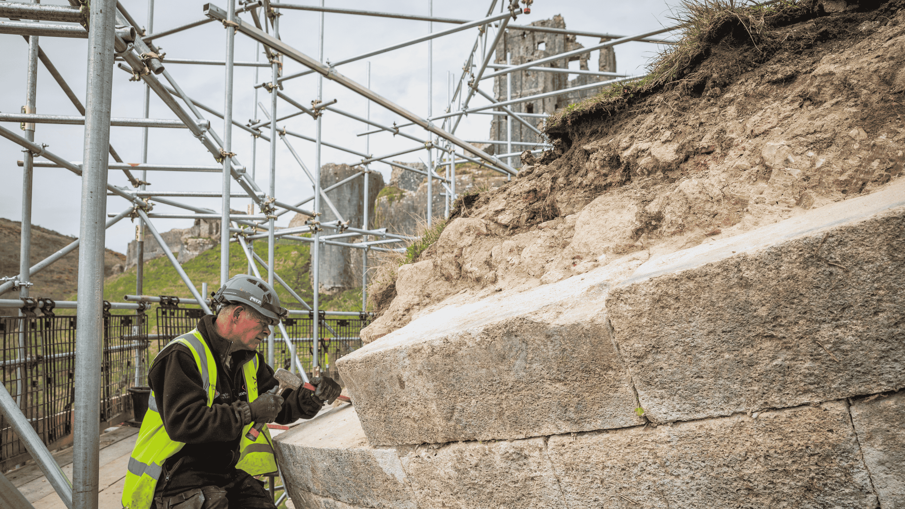 Stonemason conserving a fallen tower at Corfe Castle