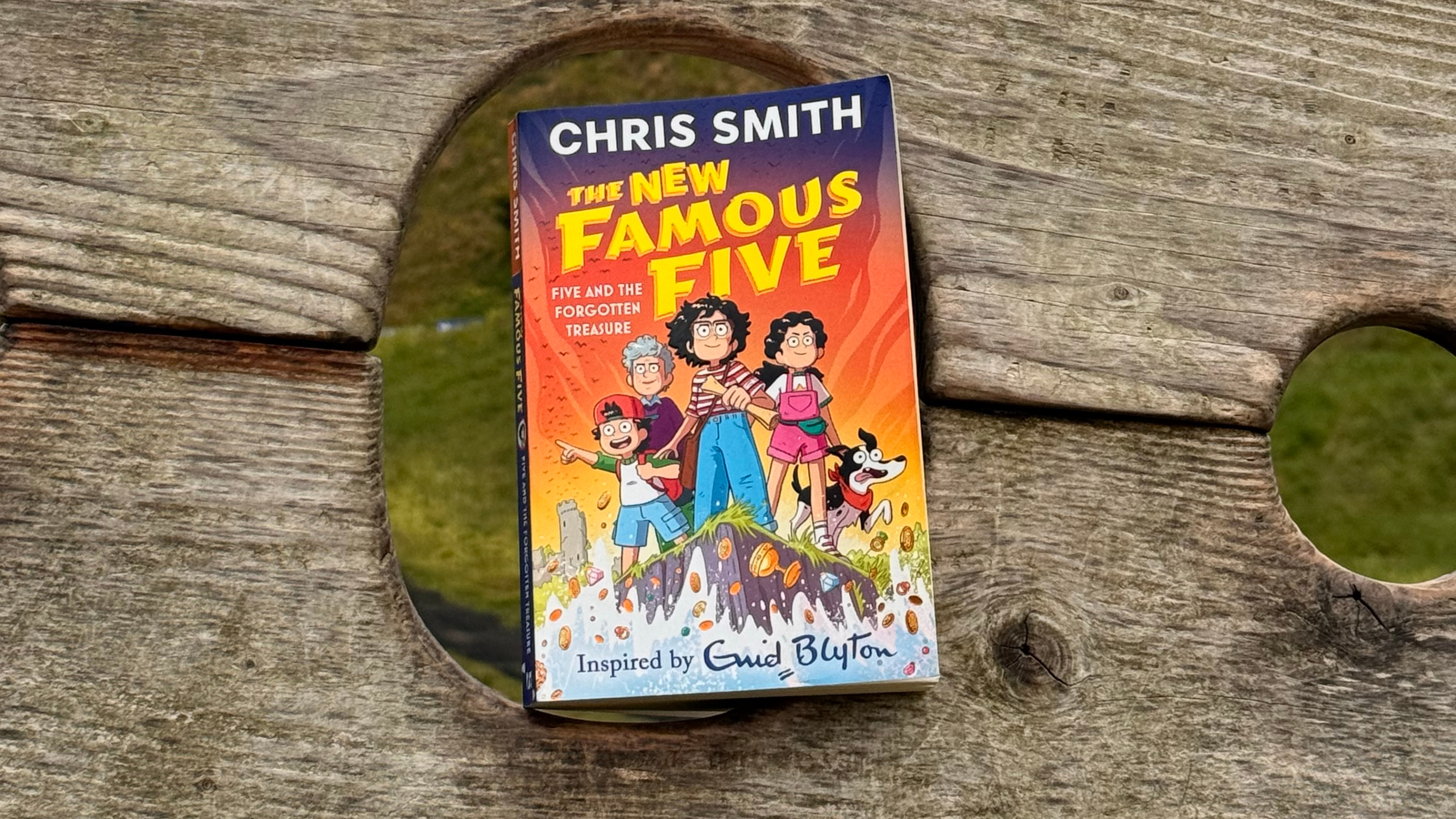 Image of a New Famous Five book in the wooden stocks at Corfe Castle
