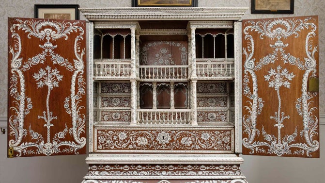 Eighteenth-century cabinet on a stand, made of wood and inlaid with ivory detail, on display in the Cabinet Room at Kingston Lacy