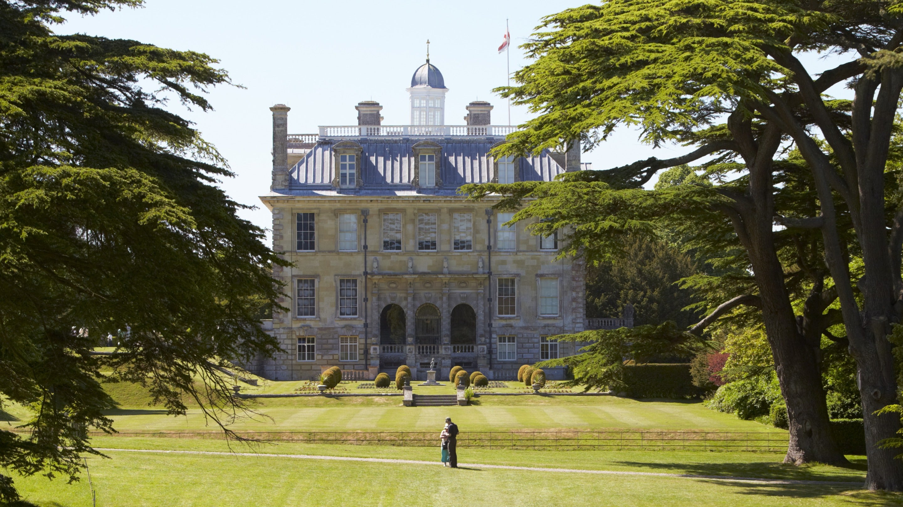 Visitors on the lawn outside the house at Kingston Lacy, Dorset.