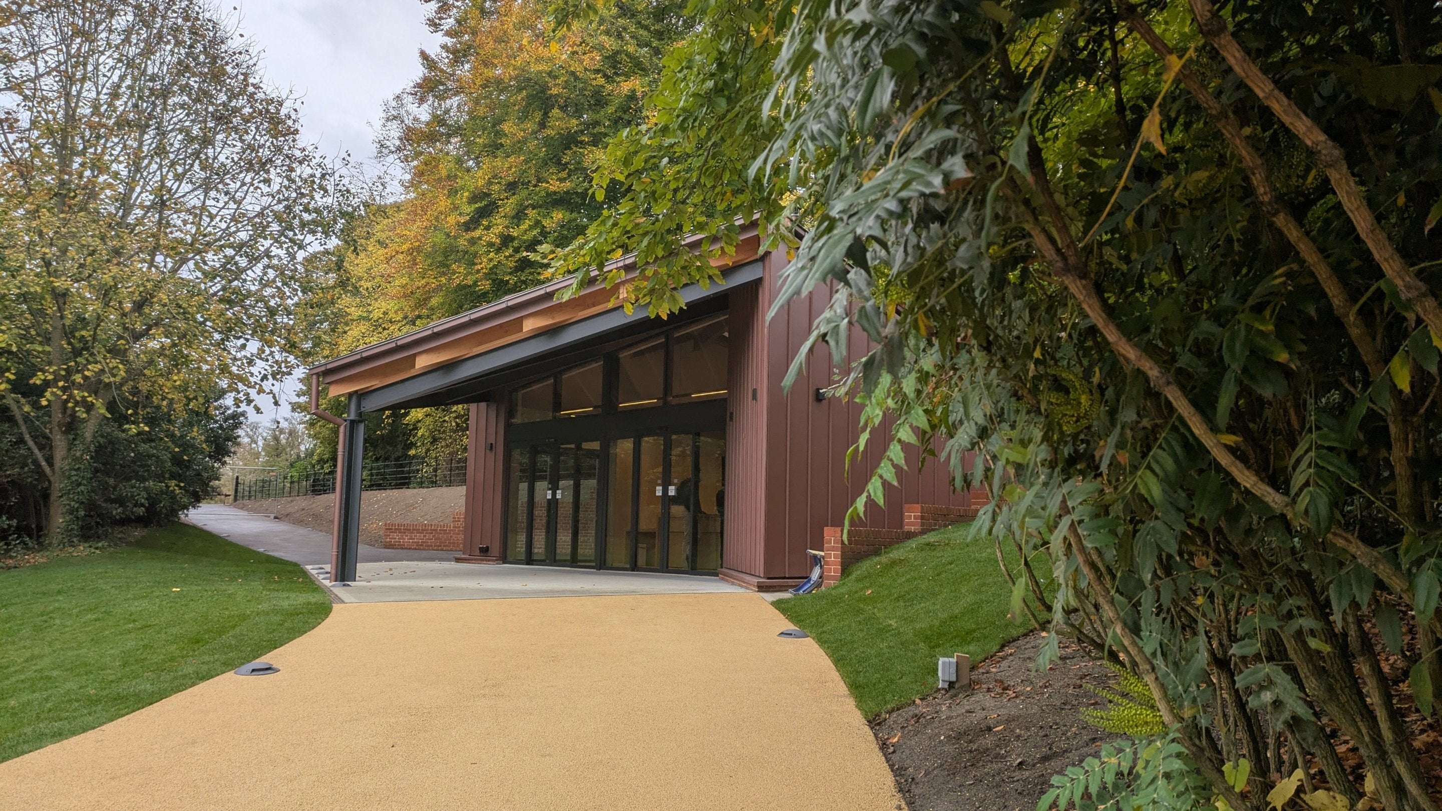 A modern building surrounded by trees and grass
