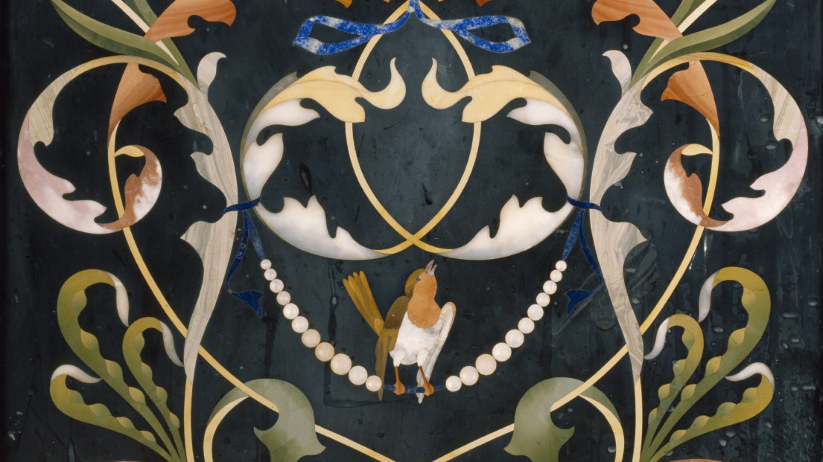 Detail of one of Florentine pietra dura panels of the cabinet in the Spanish Room at Kingston Lacy, depicting winter. In this scene, a robin is seen among foliage.