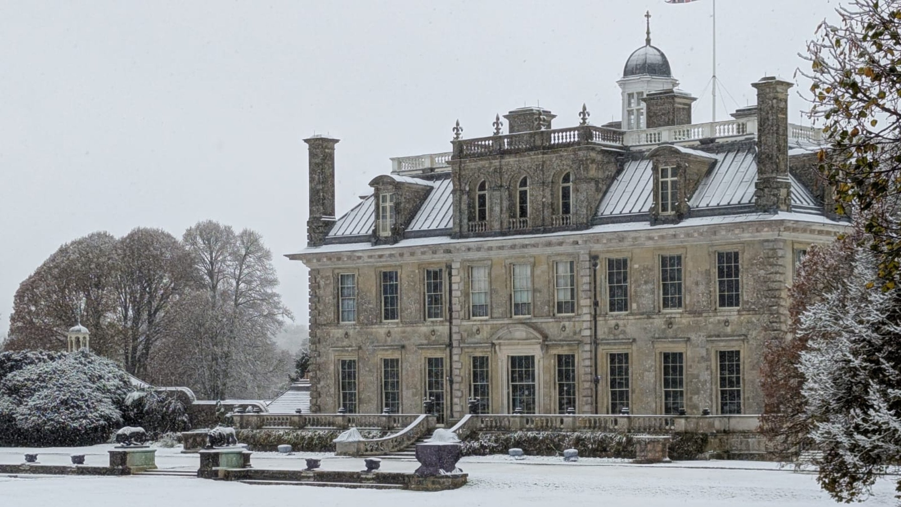 A grand stone mansion in the snow