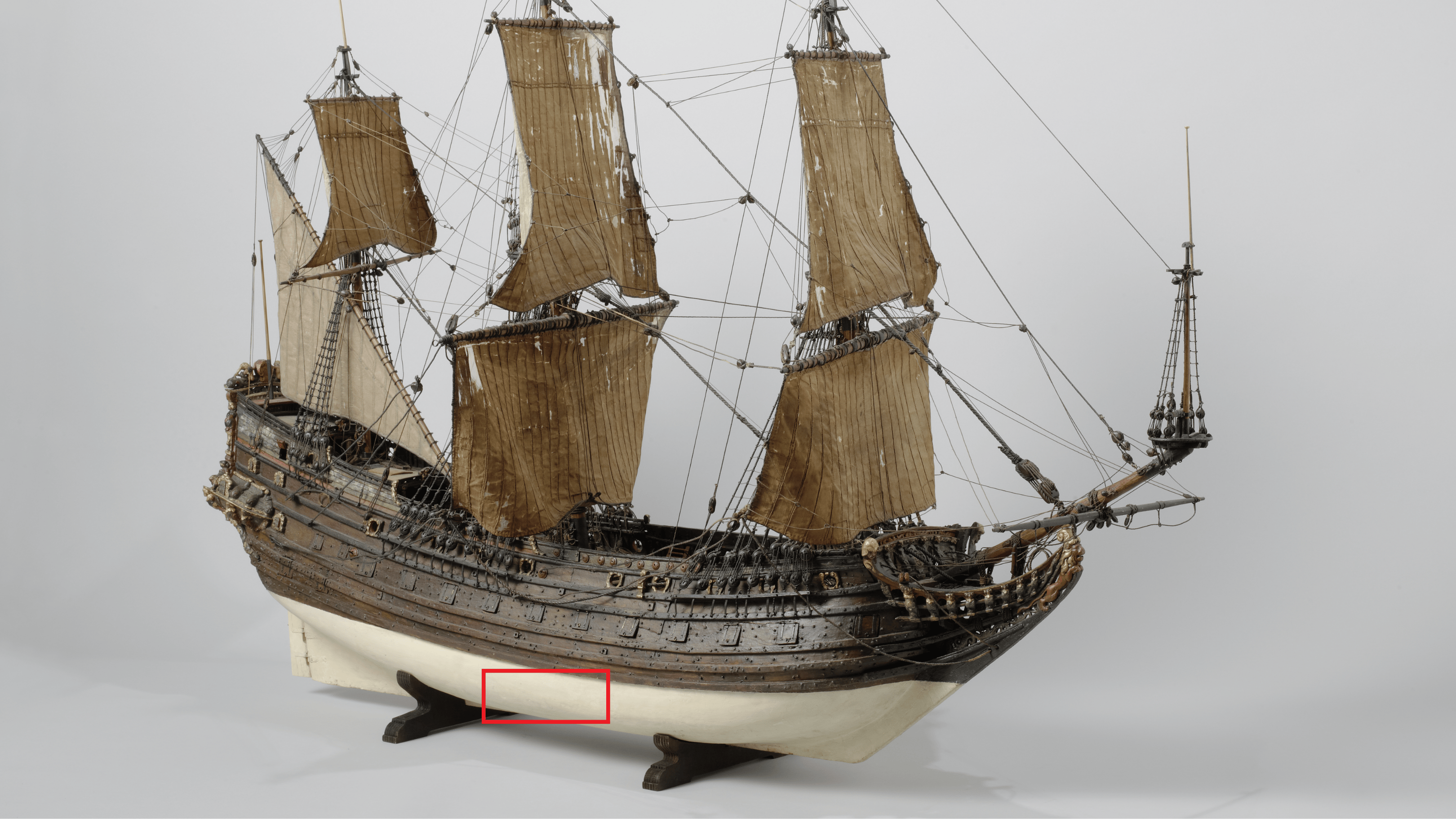 Model of 17th century merchant ship the Fame of Hoorn with red box around a section of hull to depict section likely revealed at Studland