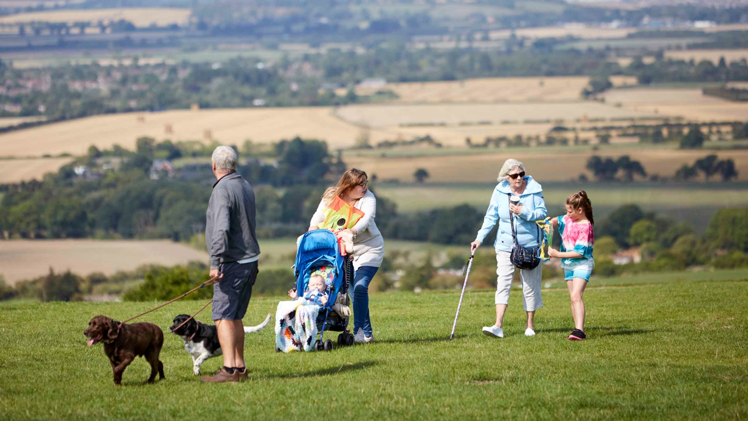 A family walking their dog at Dunstable Downs and Whipsnade Estate