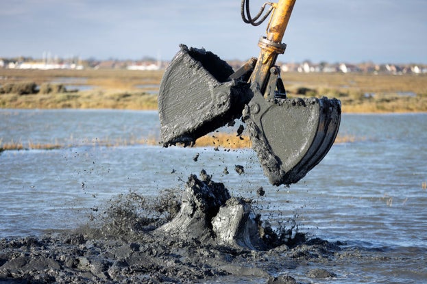 Dredged sediment being placed into the water at Northey Island