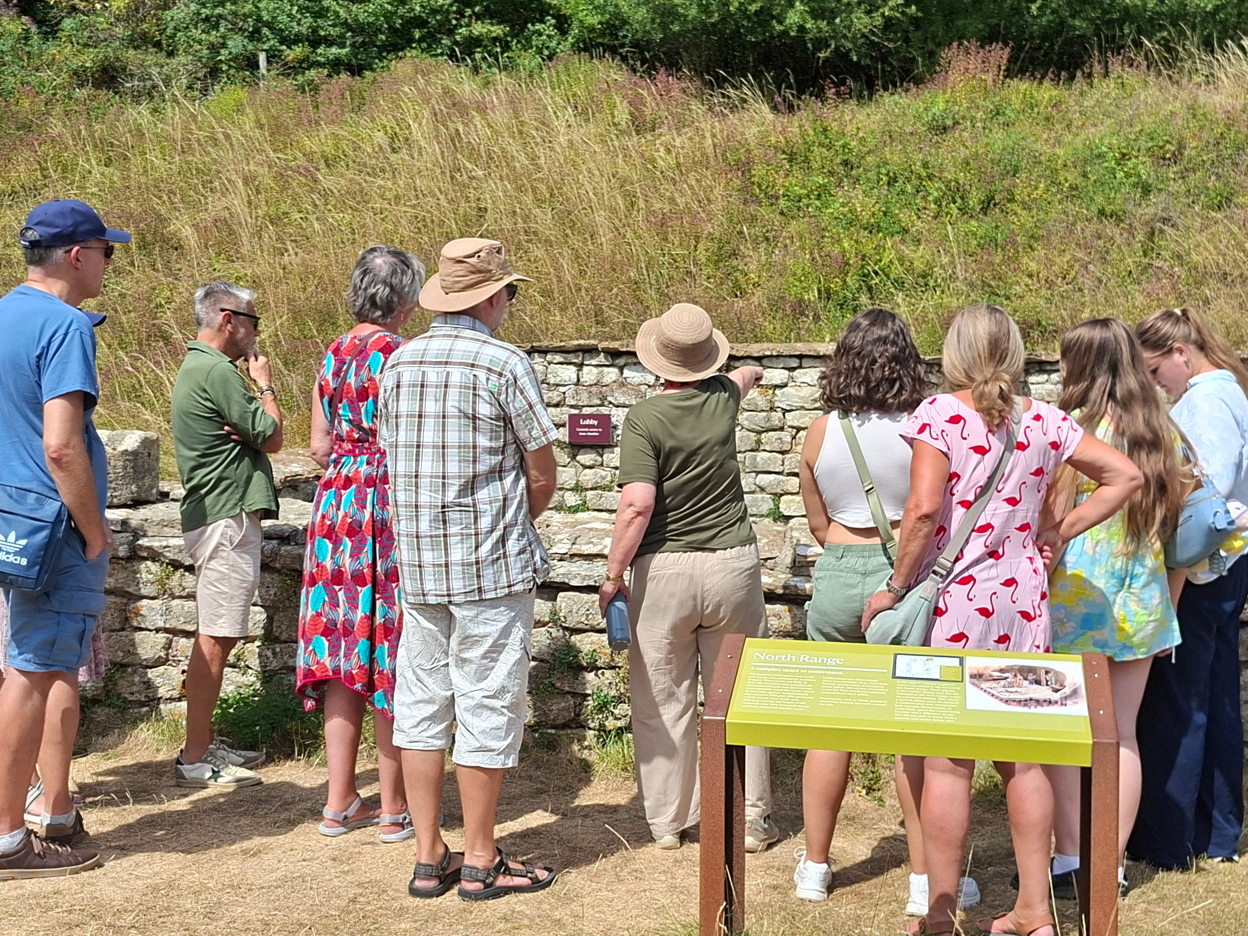 Visitors to Chedworth Roman Villa with a tour guide