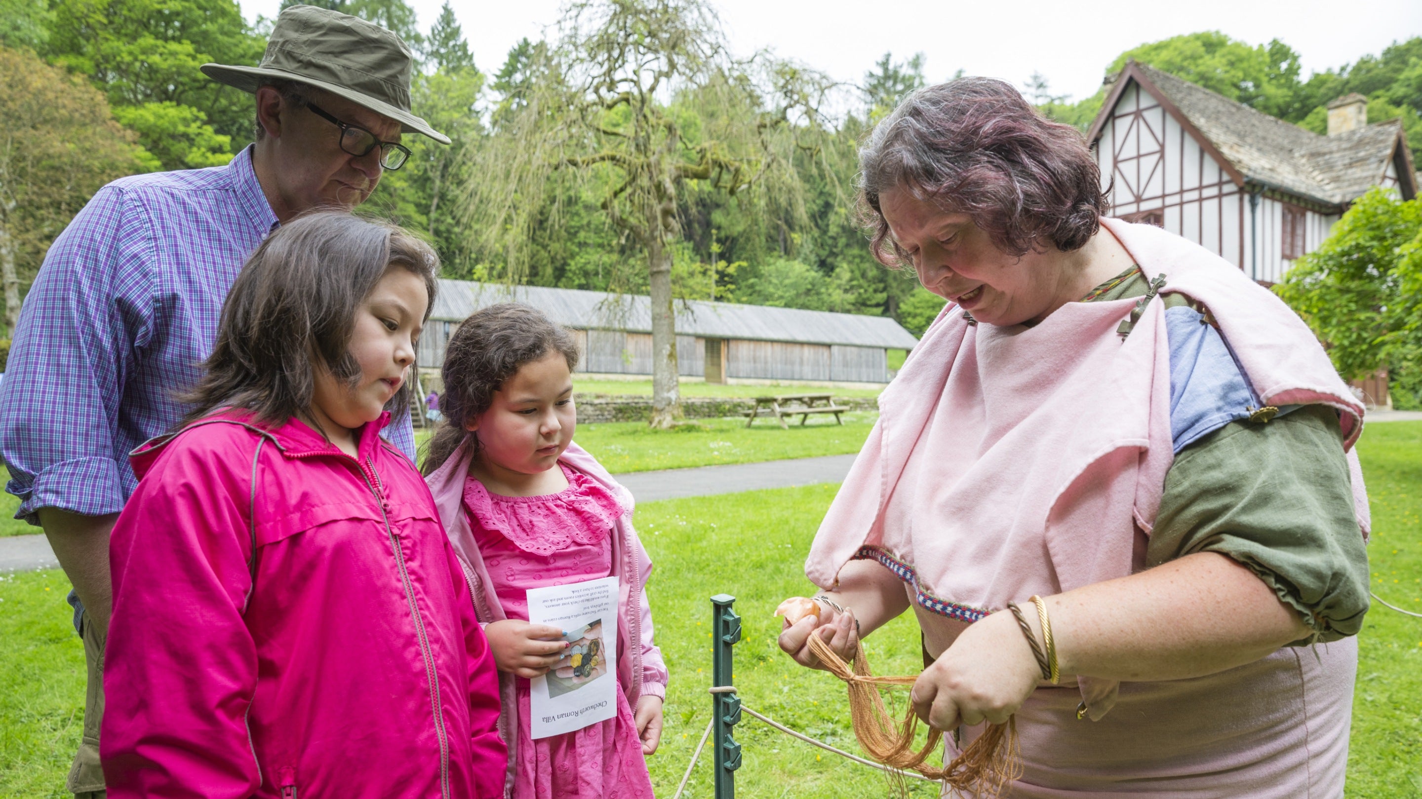 Costumed interpreter, demonstrating how the Romans dyed clothes at Chedworth Roman Villa, Gloucestershire