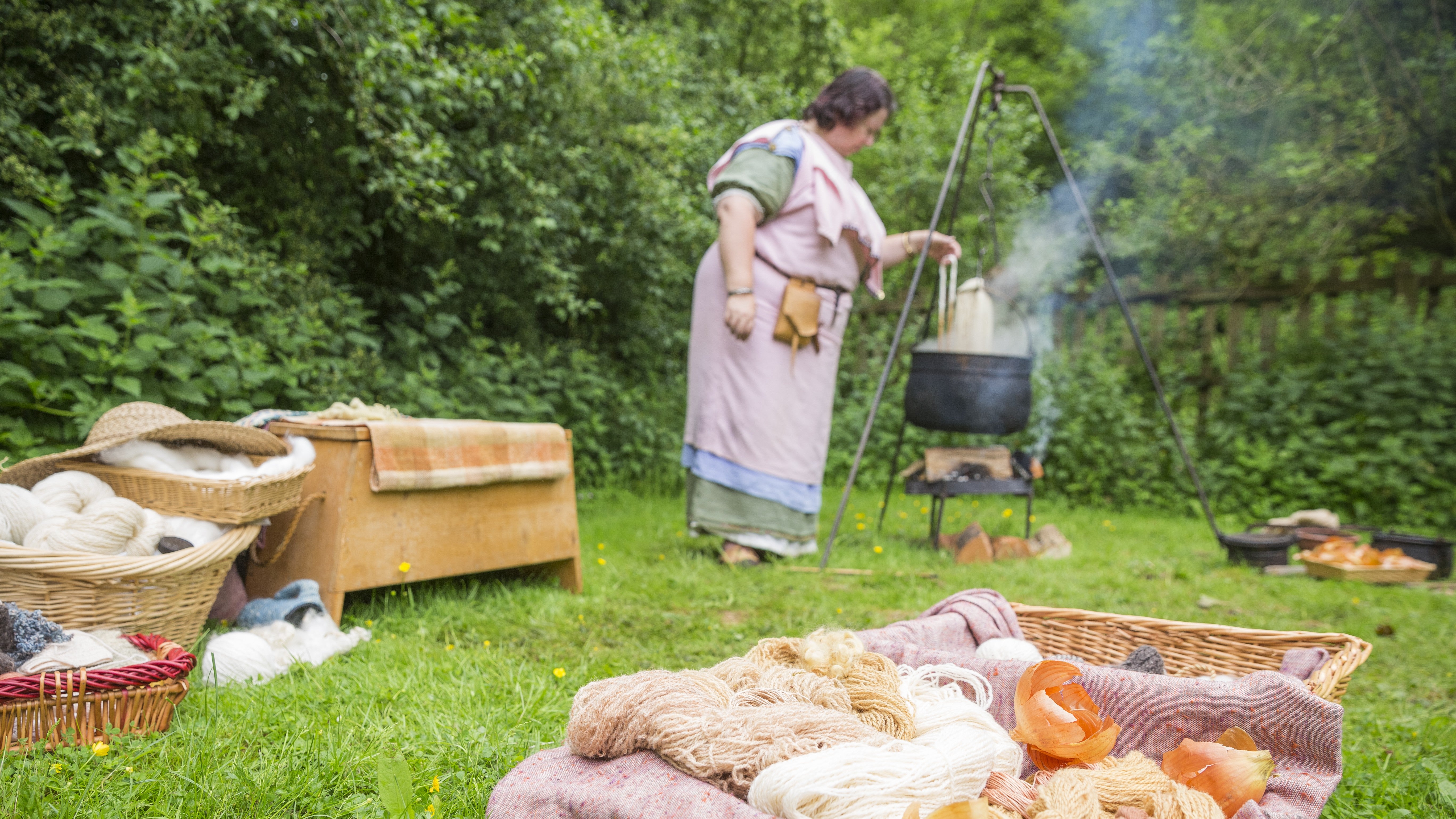 Baskets of woollen yarn and a woman in Roman dress with a caldron