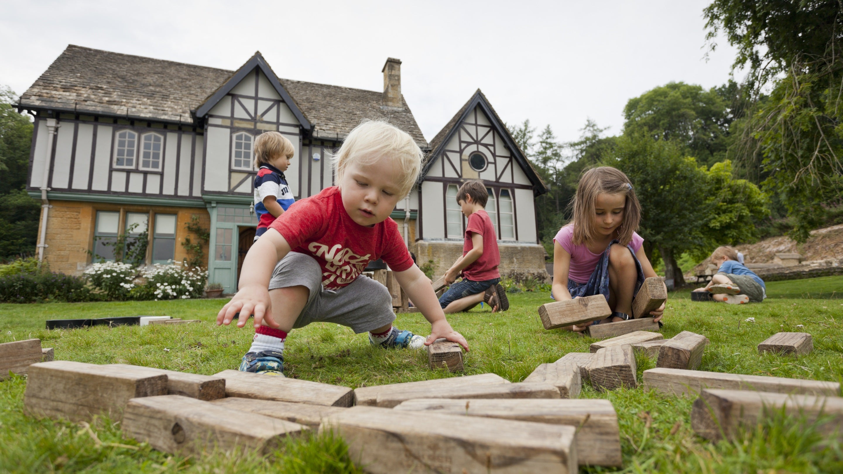 Children playing with garden games at Chedworth Roman Villa, Gloucestershire.