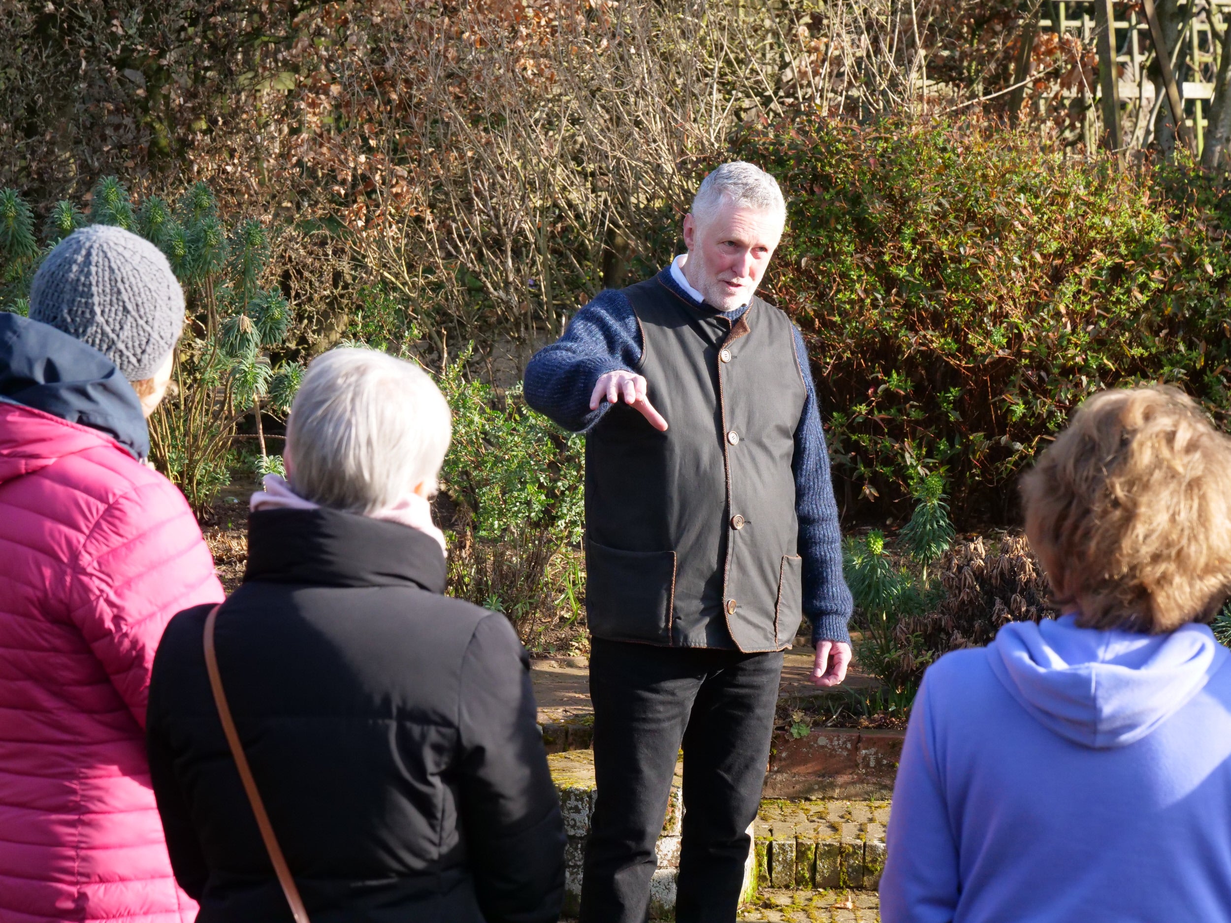 A guide giving a talk in a garden