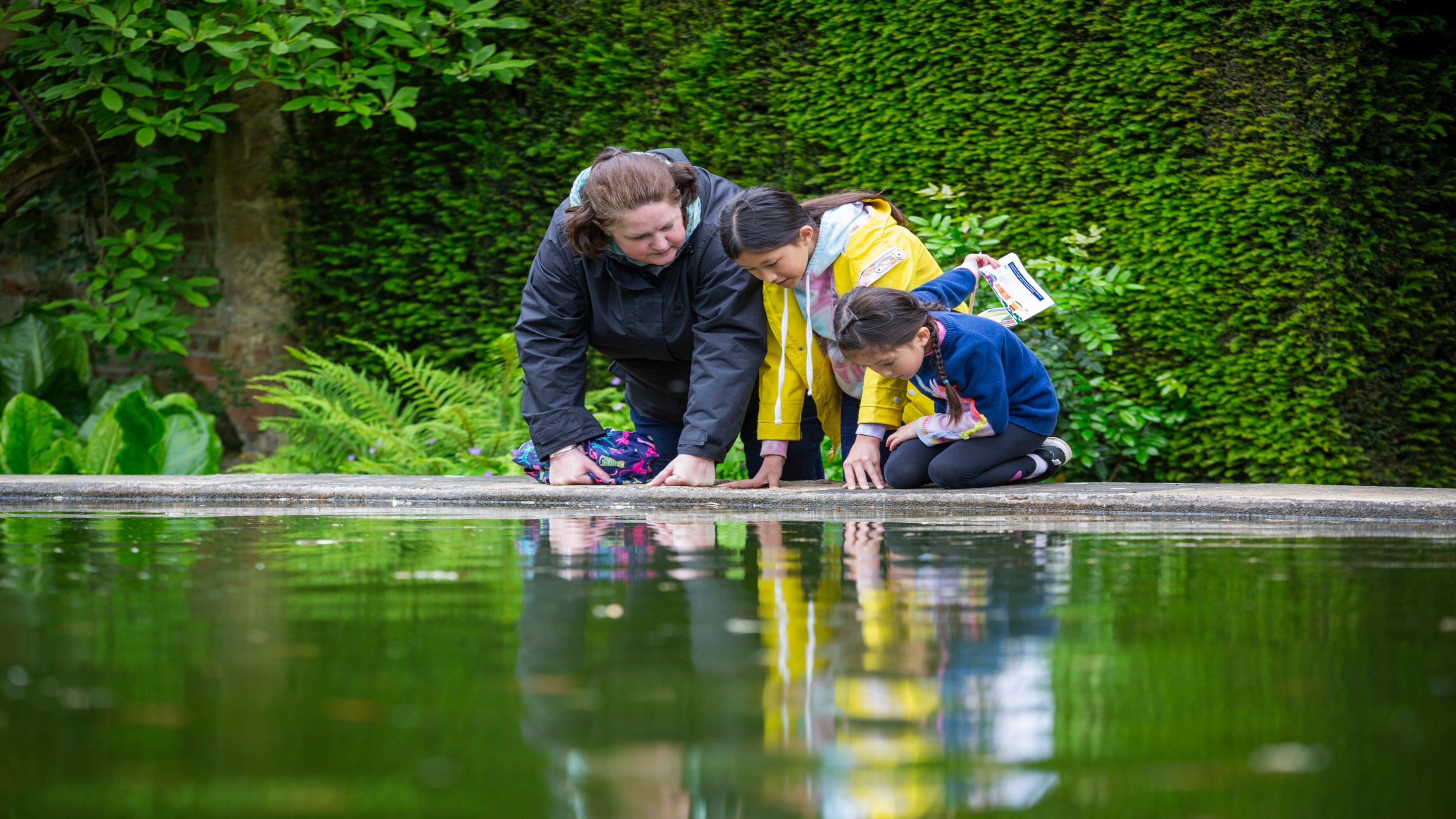 Family looking into Mirror Pool