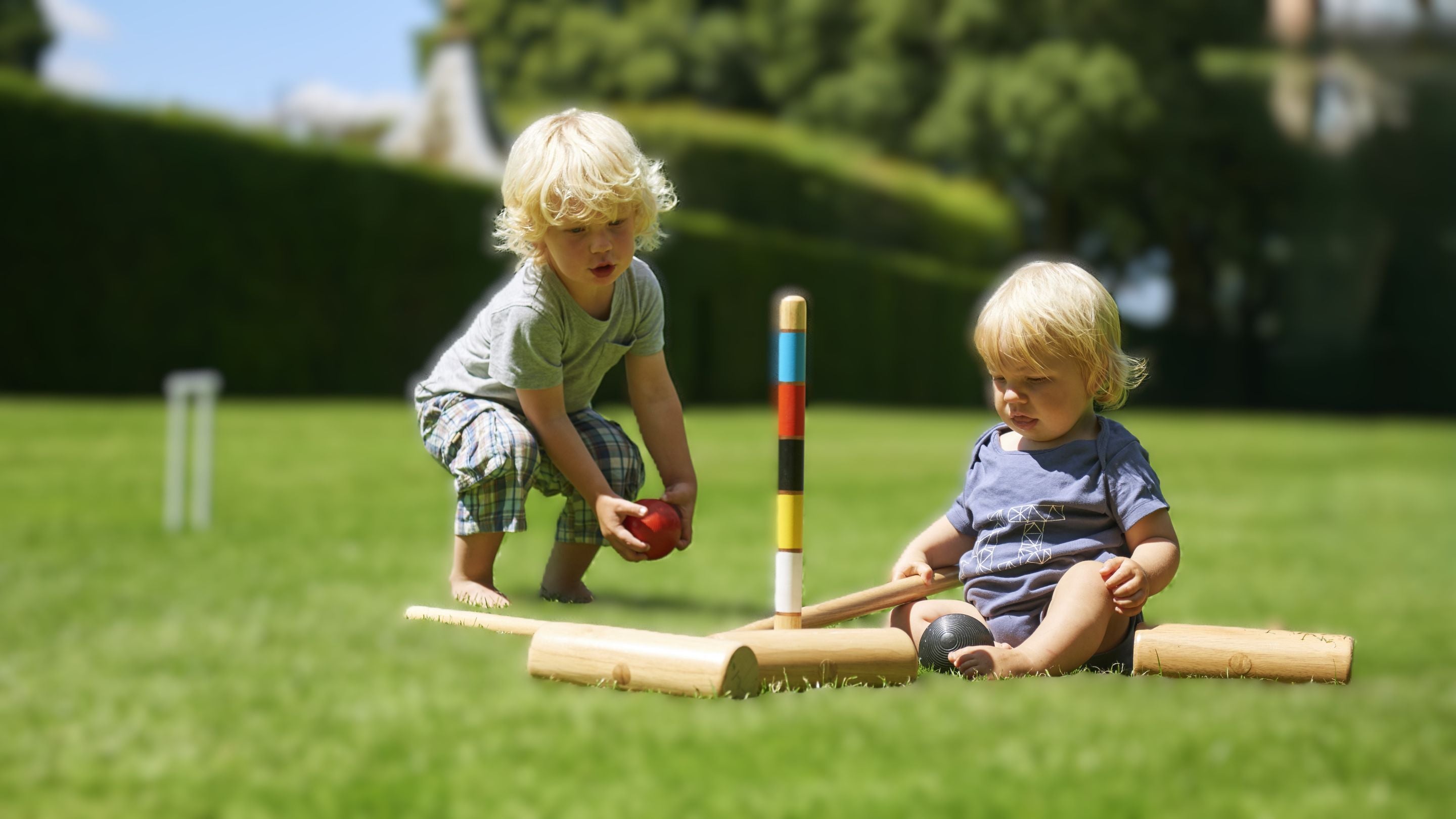 Young children with croquet equipment on Great Lawn at Hidcote